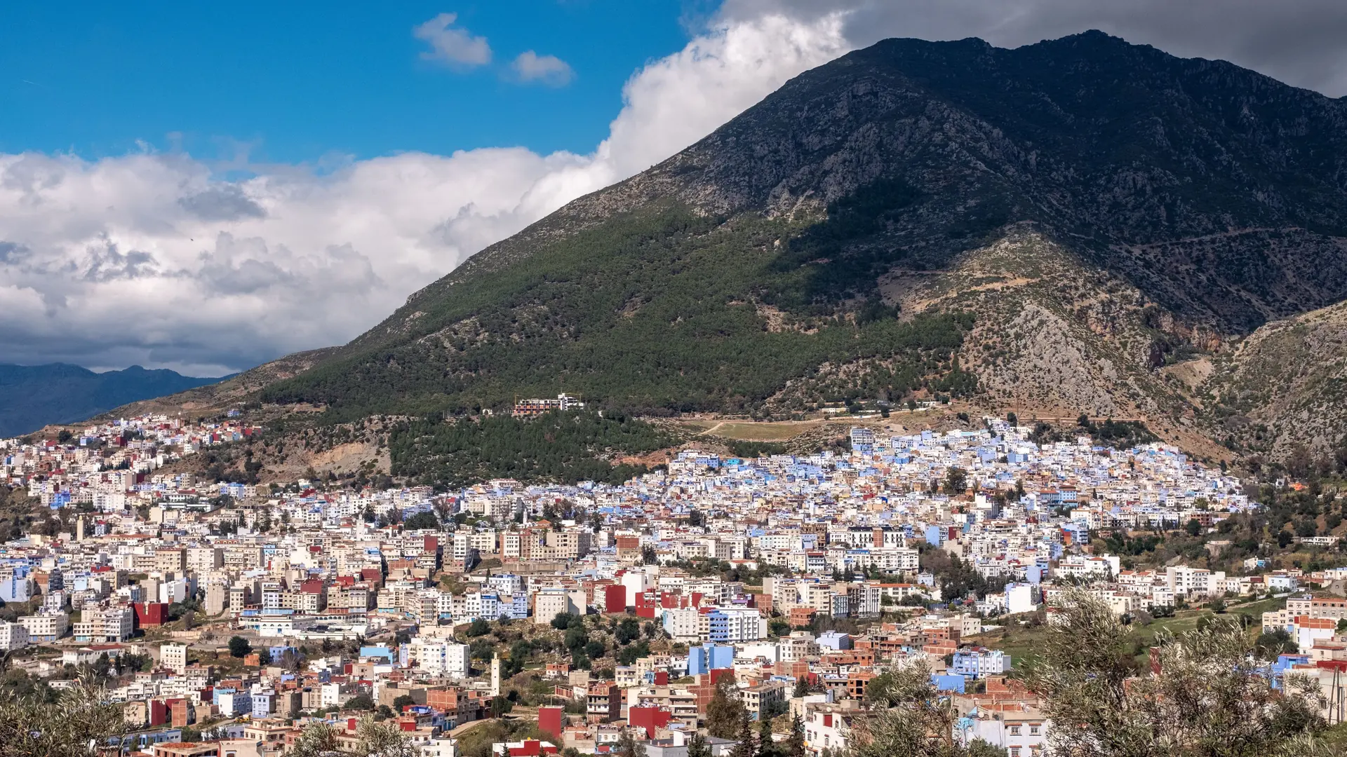 Chefchaouen town climbing the Rif hillside beneath a blue sky
