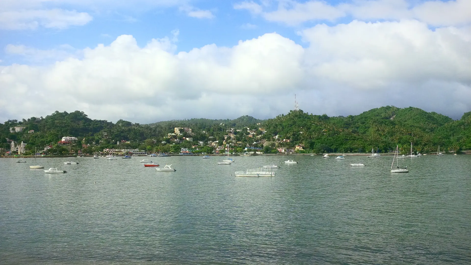 Bright view across Samaná Bay toward the town and boats