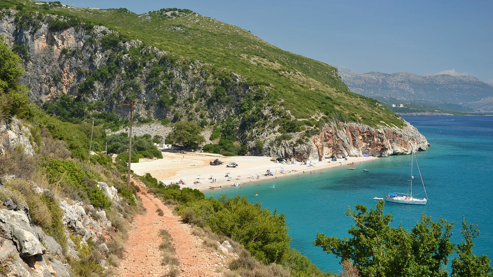 A footpath leading down to Gjipe beach and turquoise water on the Albanian Riviera