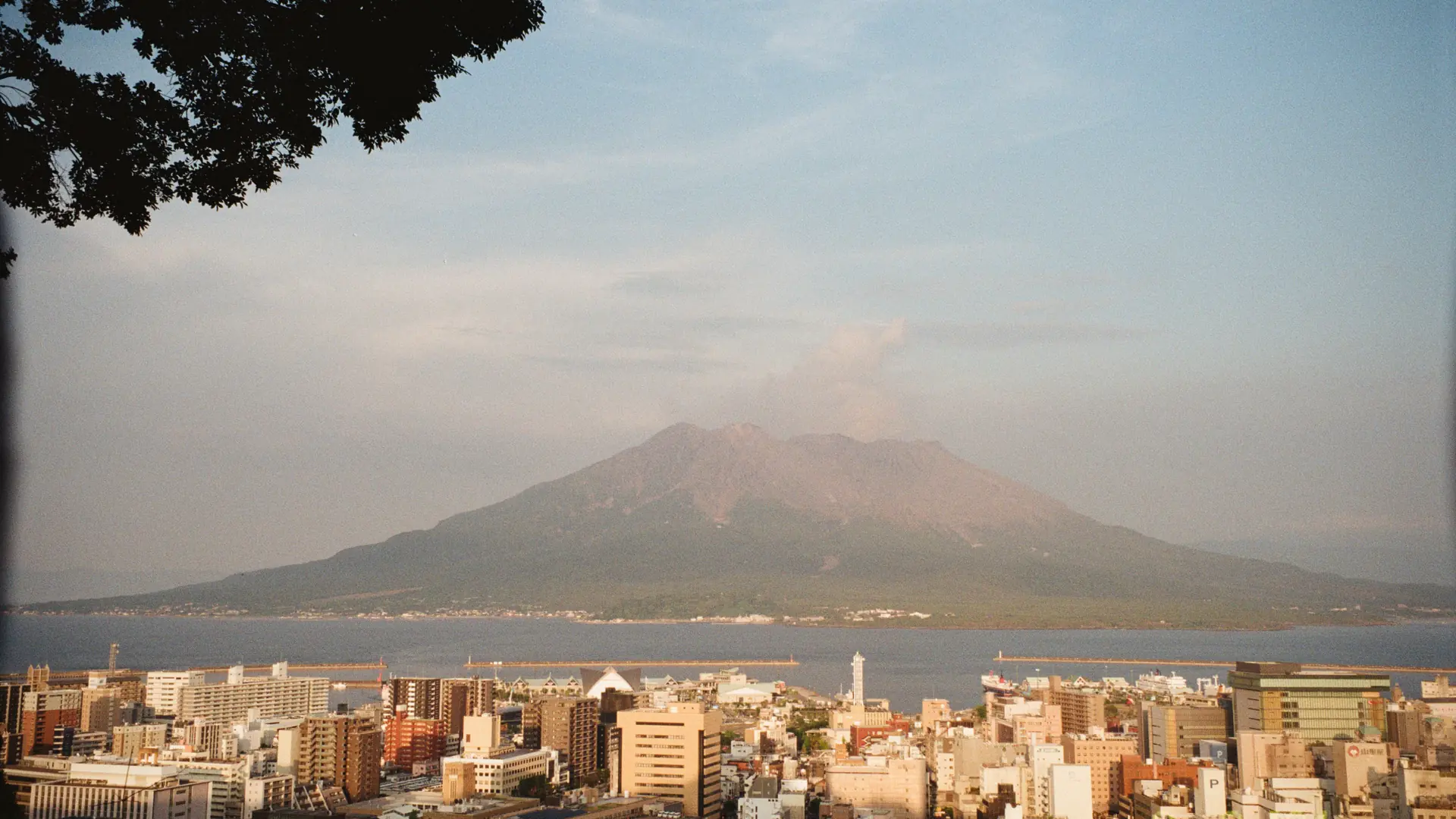 Mount Fuji rising beyond Lake Ashi and Hakone hills in clear morning light