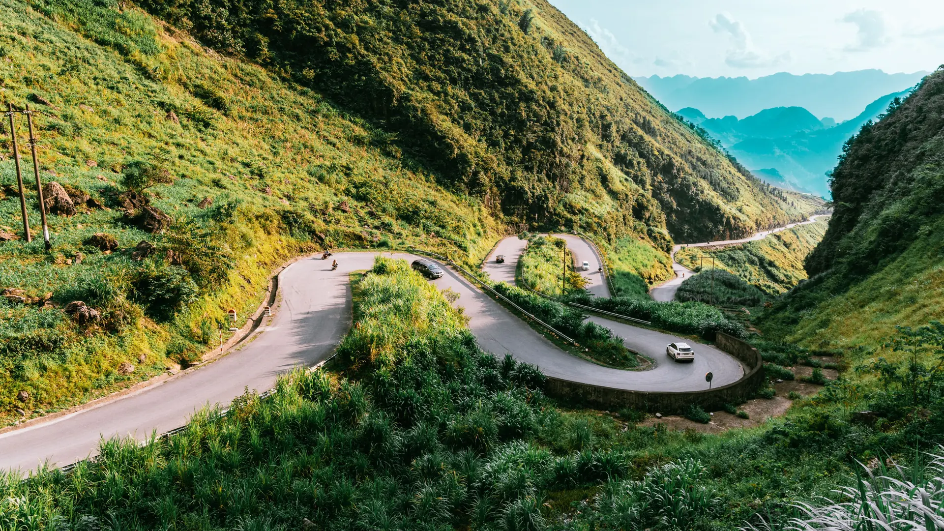 The winding road through green limestone hills in Ha Giang