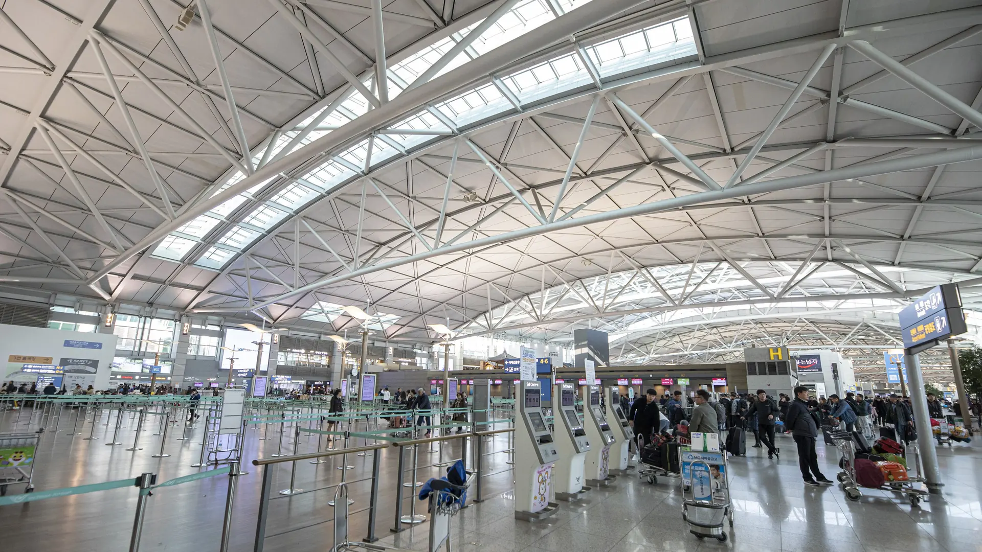 Check-in counters beneath the steel roof of Incheon International Airport Terminal 1 departures