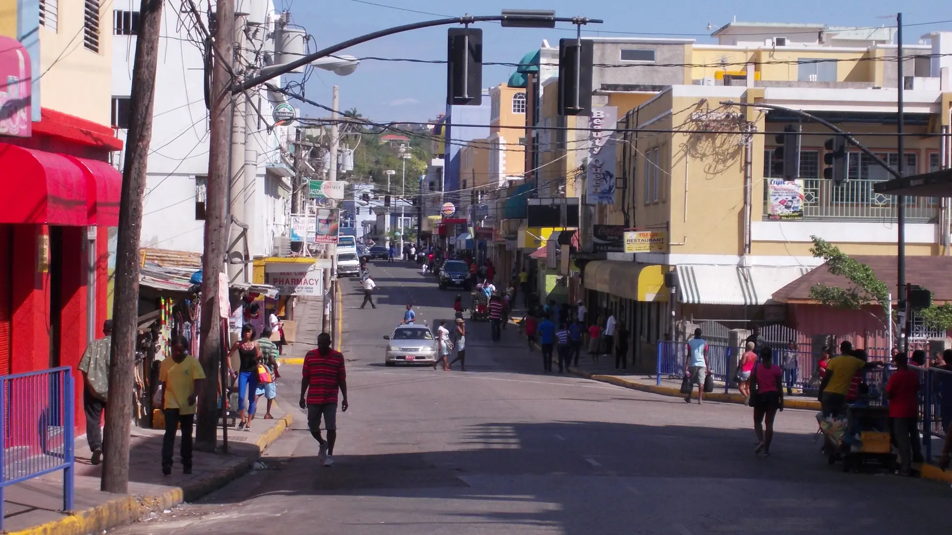 Shops and pedestrians on a sunny street in Montego Bay