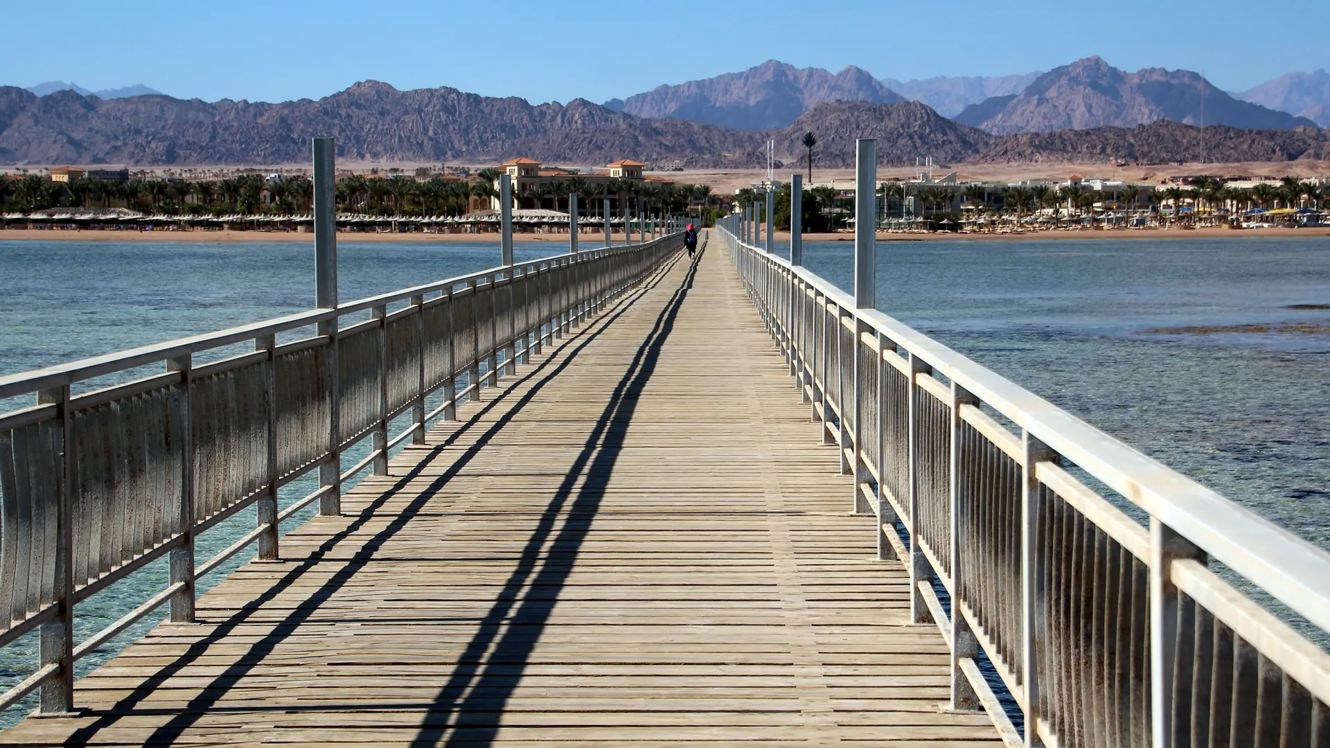 Sunlit Nabq Bay hotel coast and mountains seen from a jetty in Sharm El-Sheikh