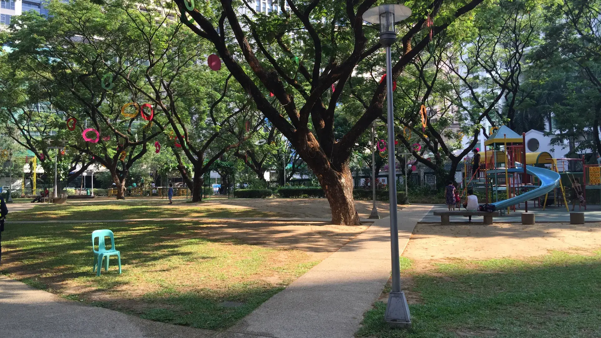 Trees and the playground in Salcedo Park, Makati