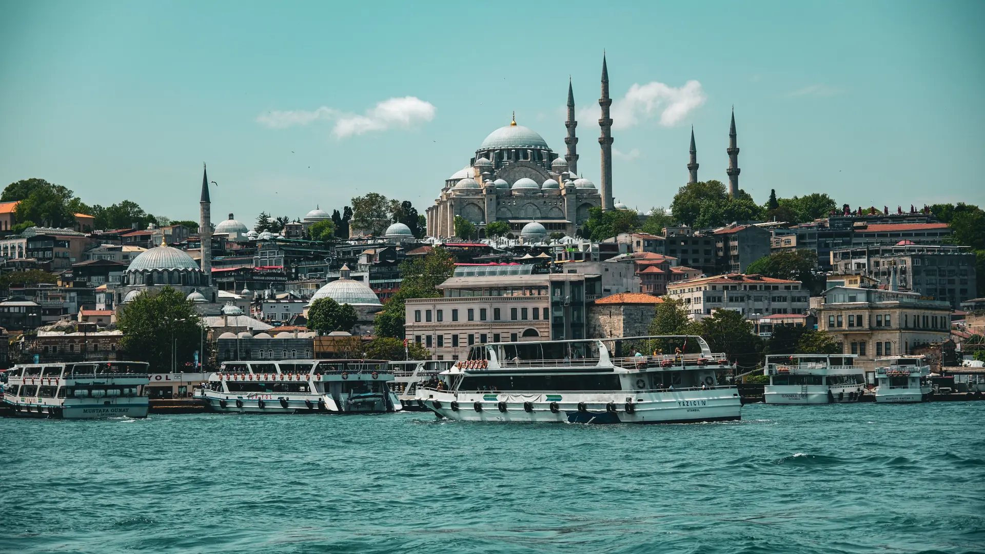Istanbul ferry crossing the sparkling Bosphorus beneath mosque minarets