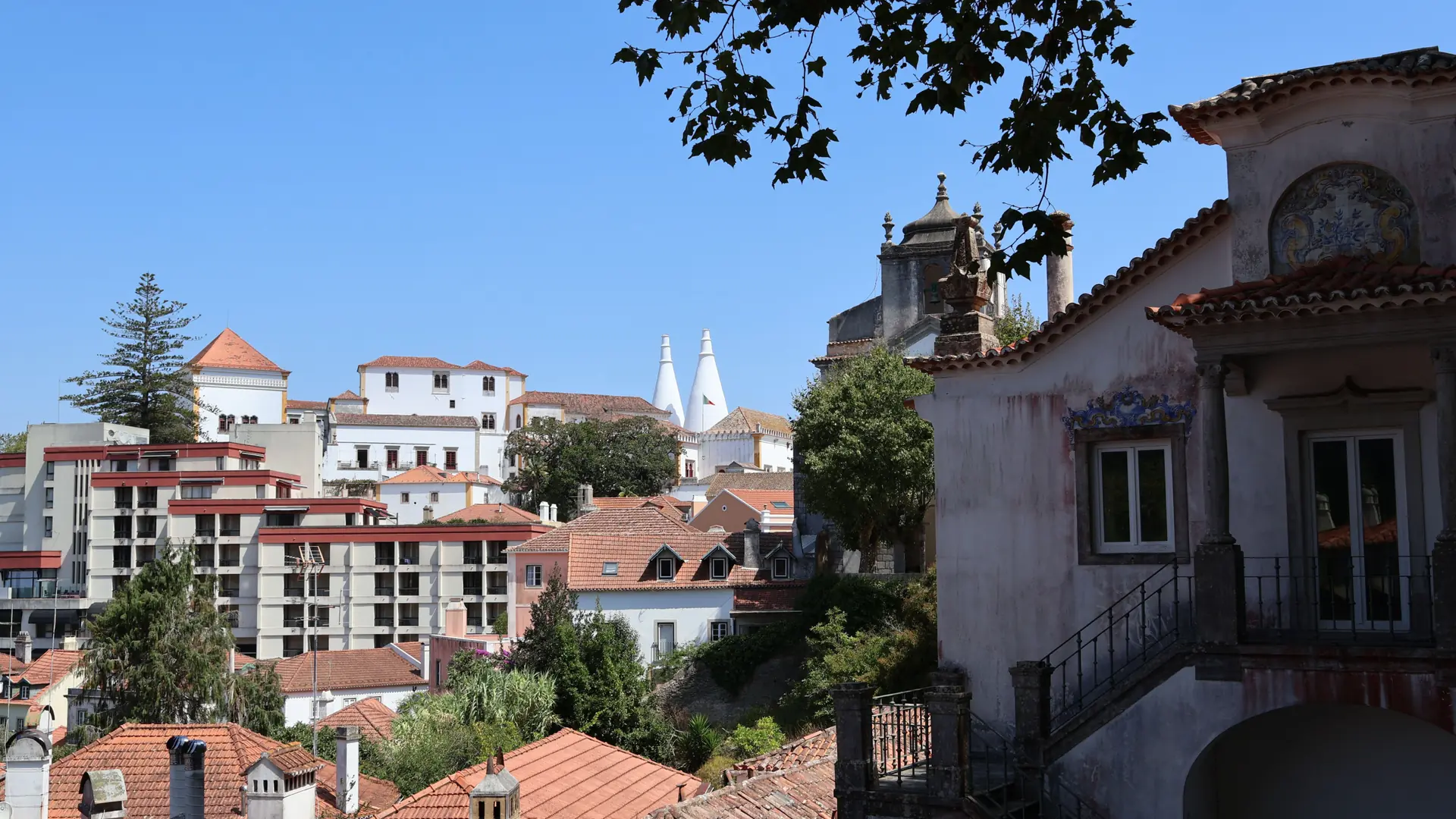 Traditional Sintra buildings and tiled roofs beneath a clear blue sky