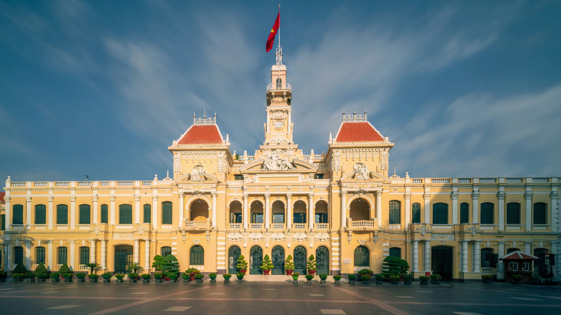 Ho Chi Minh City Hall with red roofs beneath a bright blue sky
