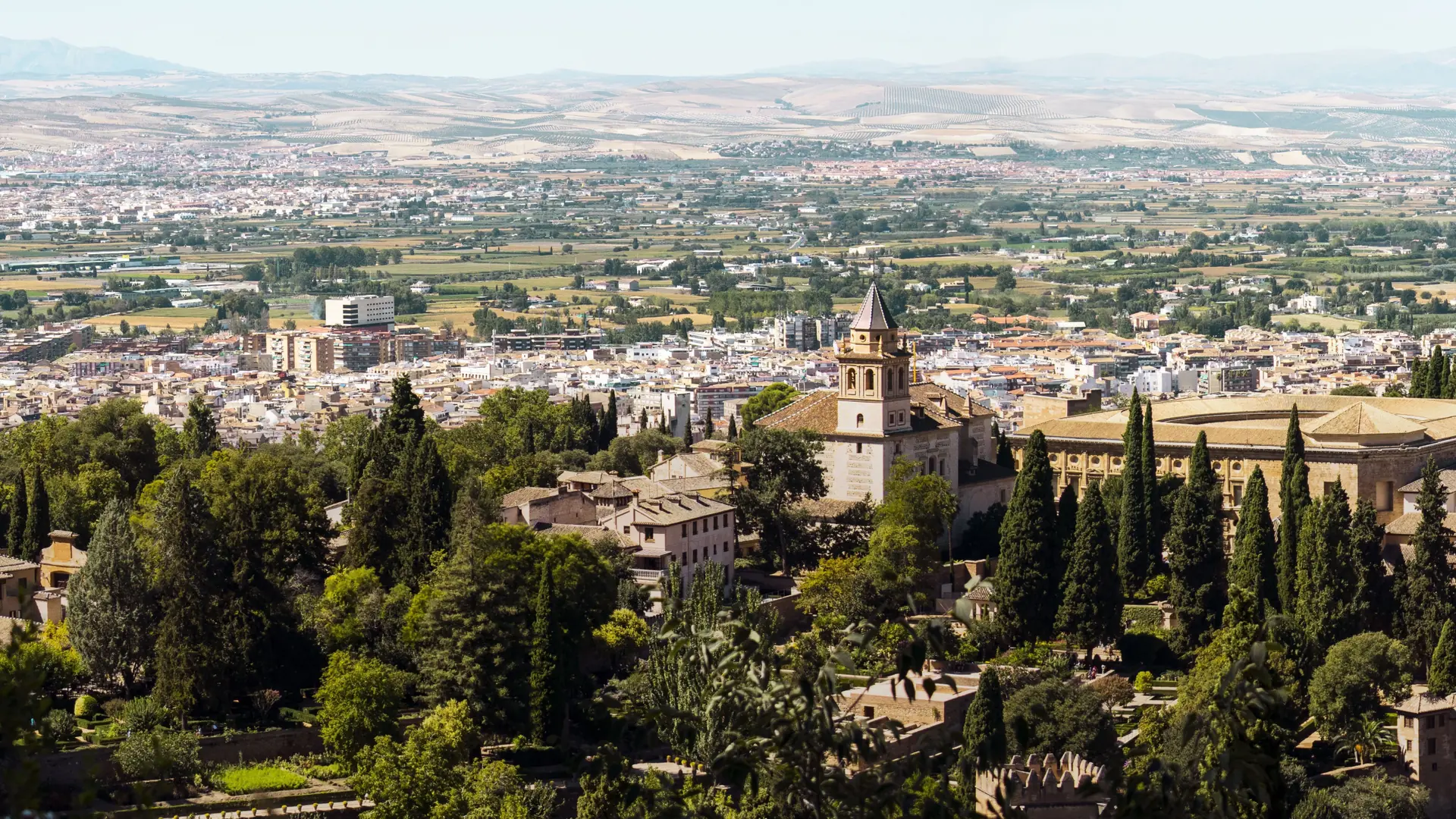 Santa María de la Alhambra church and the Palace of Charles V above the Granada plain