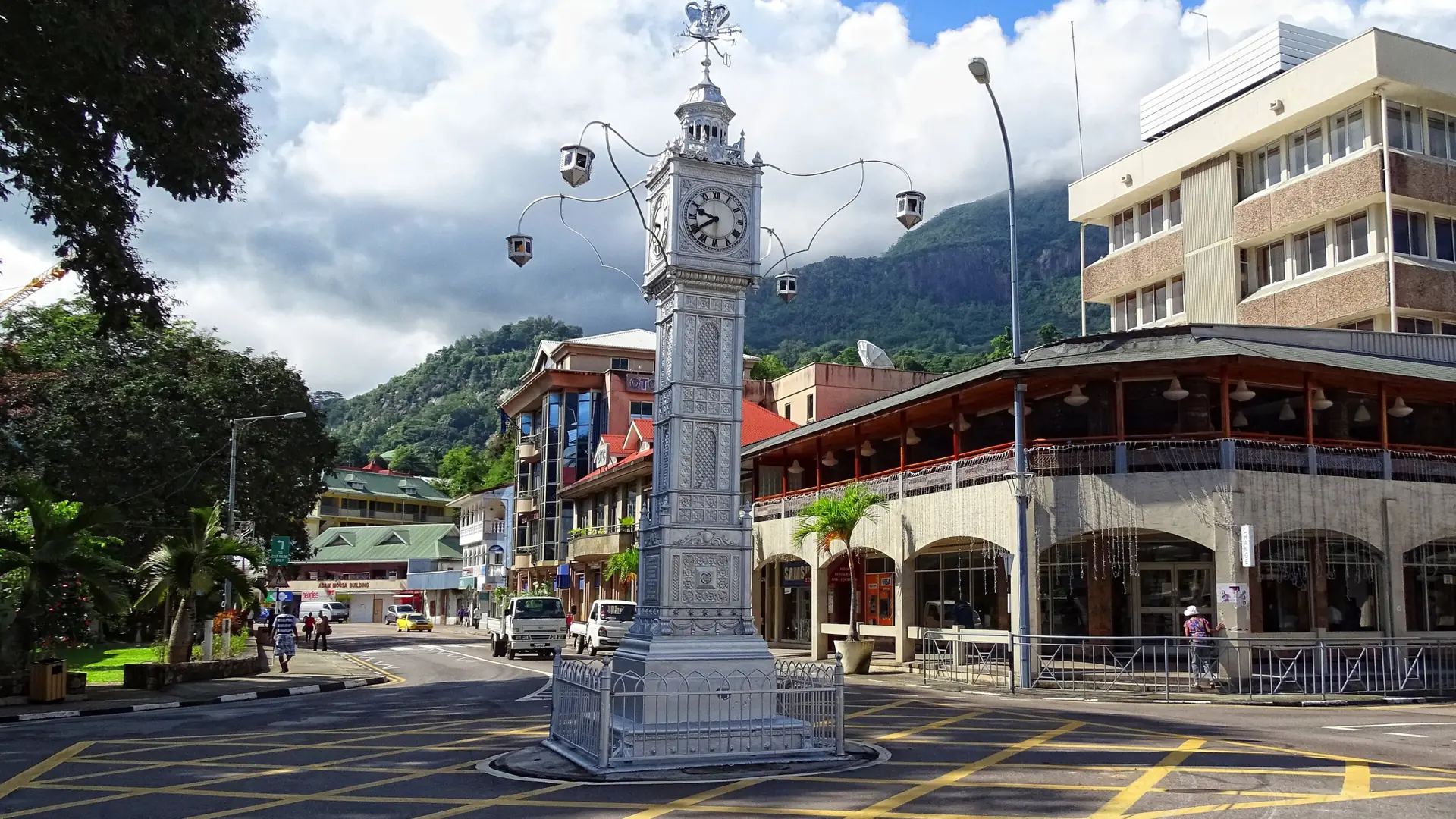 Victoria Clock Tower at a central junction with city buildings and a blue sky