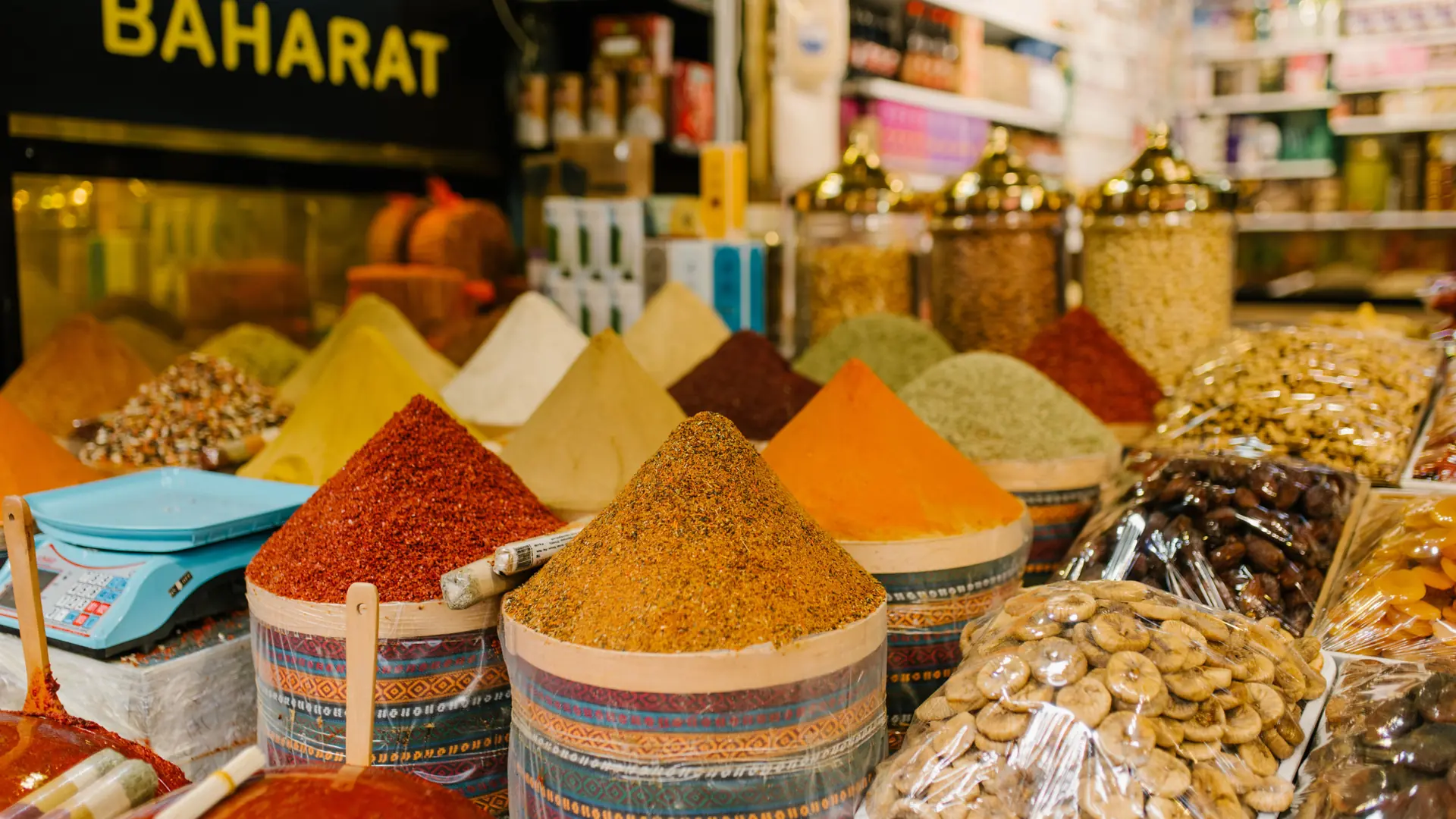 Colourful spices, tea and local produce displayed in a sunlit Turkish market
