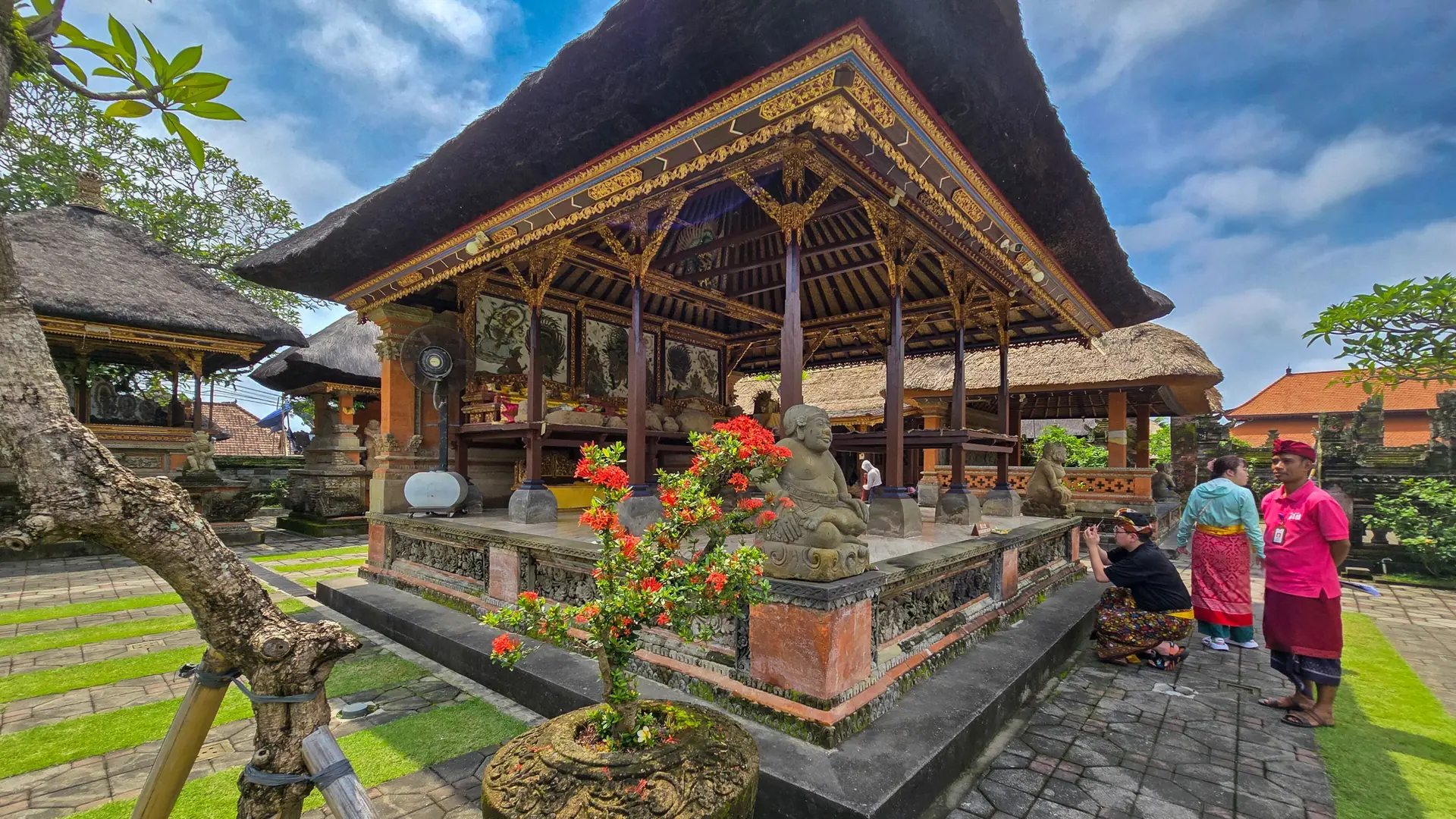 An ornate pavilion and flowering courtyard at Puri Saren Agung in Ubud