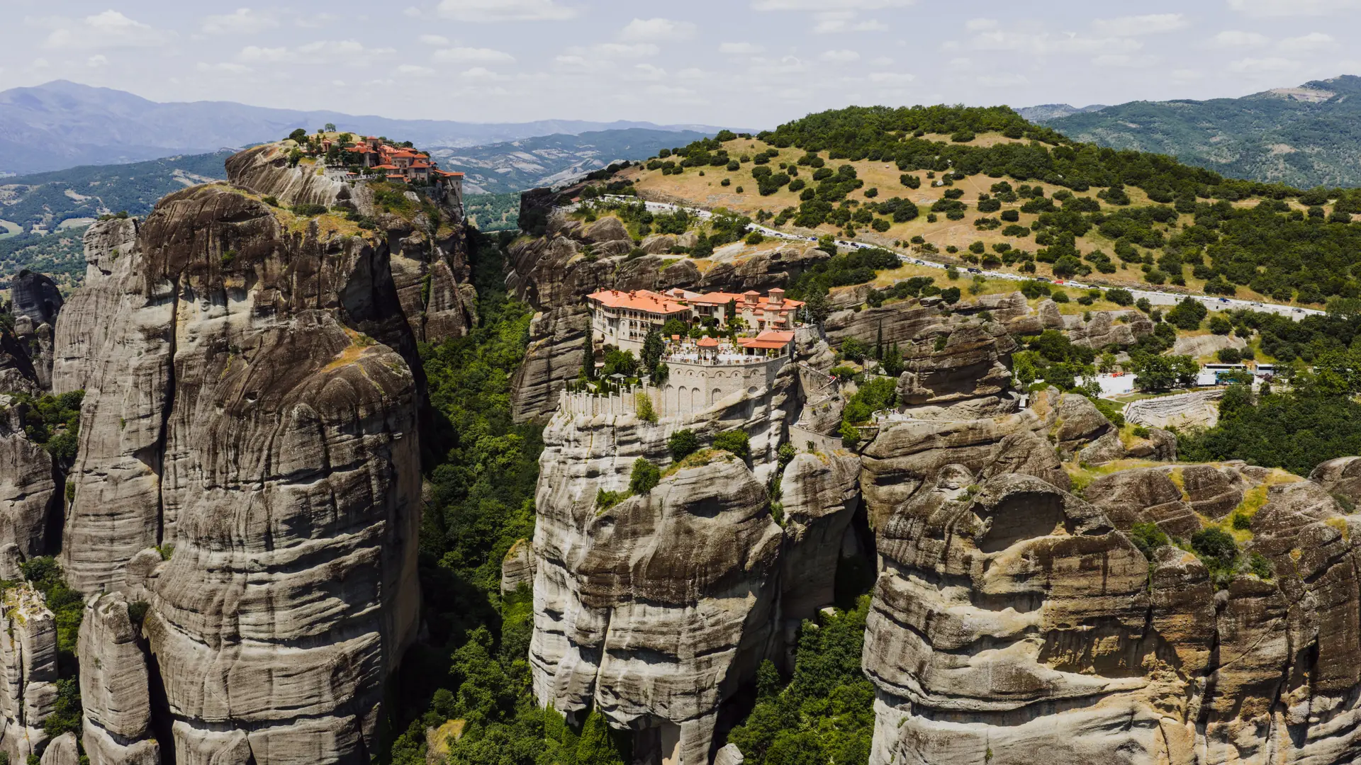 Sunlit Meteora monasteries perched across towering sandstone pillars in central Greece
