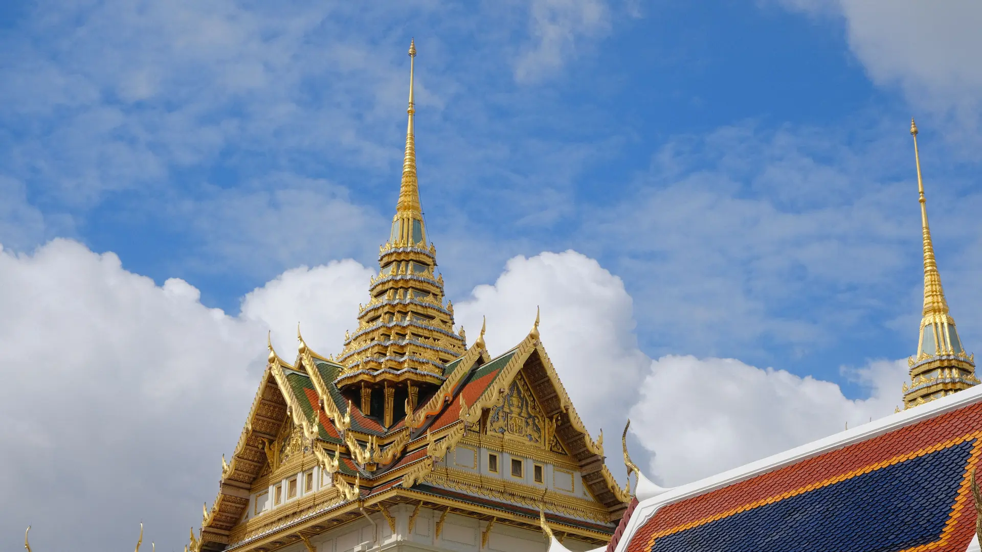 Sunlit Grand Palace rooftops in Bangkok
