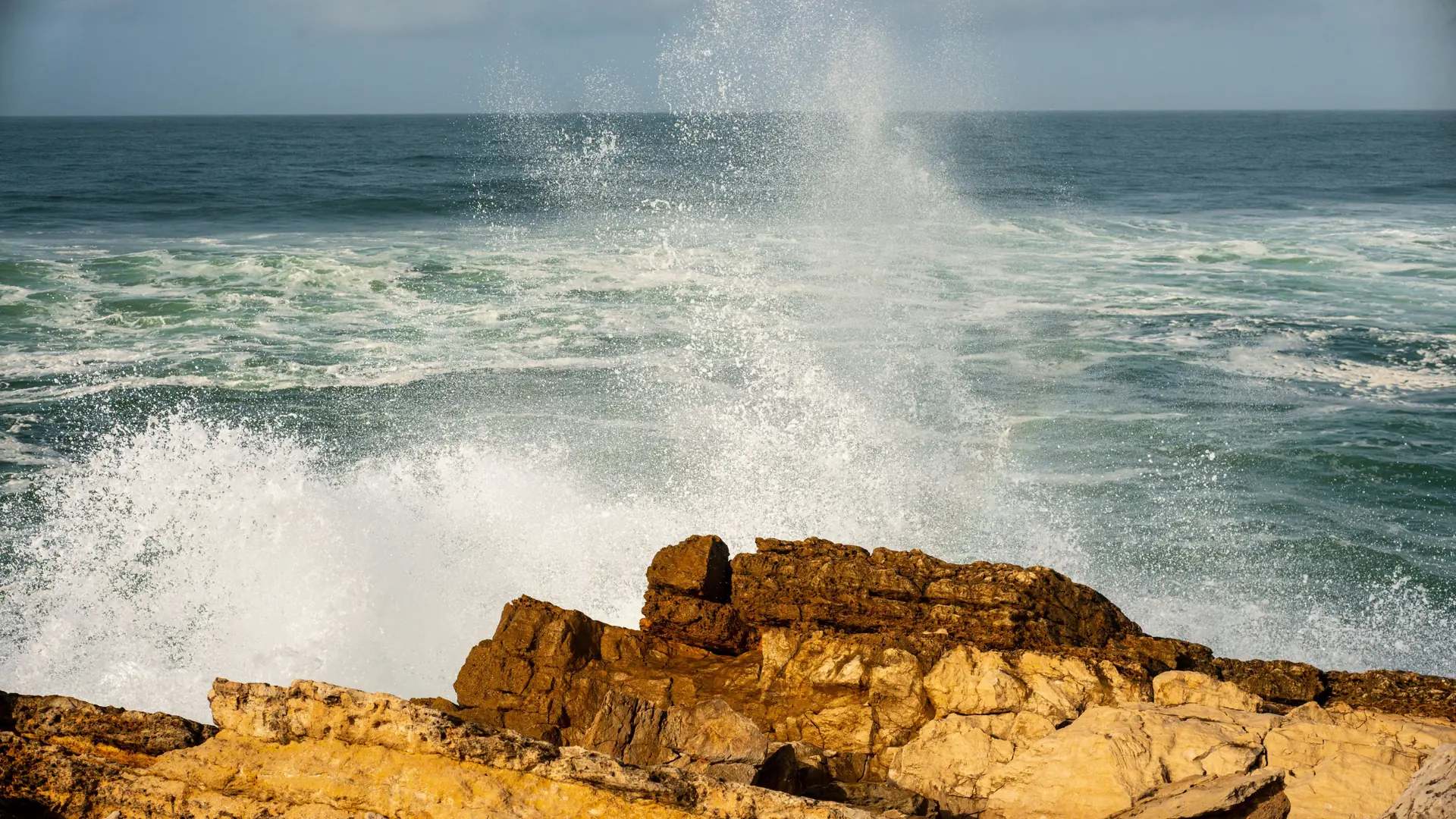 Atlantic waves breaking against the rocky Cascais shoreline