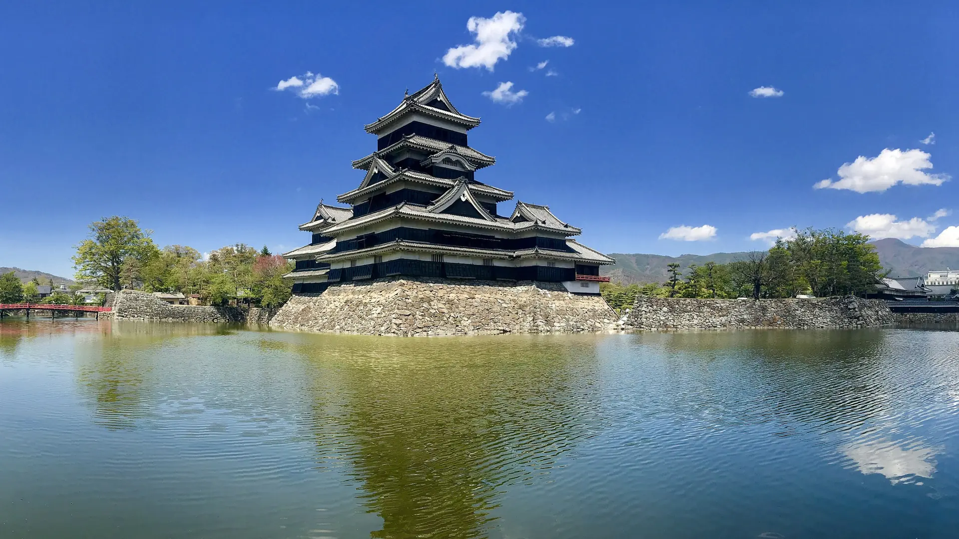 Black timber walls of Matsumoto Castle above its moat