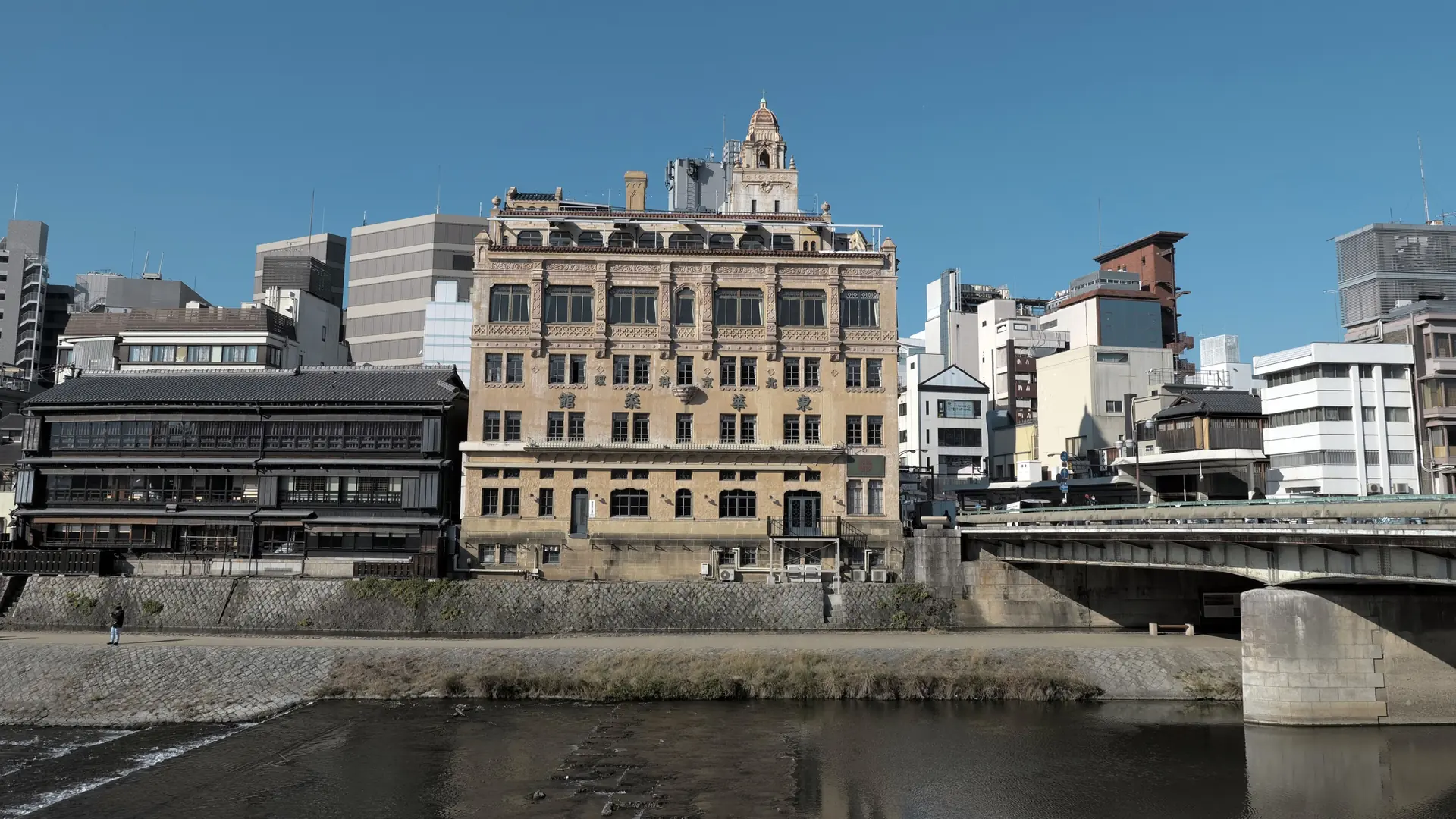 Tohkasaikan’s ornate facade beside Shijo Bridge and the Kamo River in sunny Kyoto.