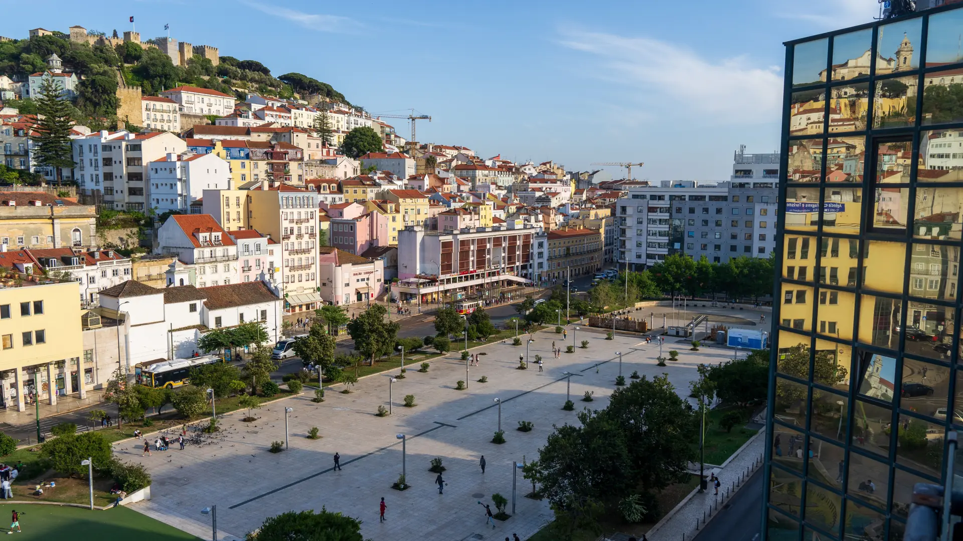 Praça Martim Moniz and São Jorge Castle hill in Lisbon in daylight; wider central-city context
