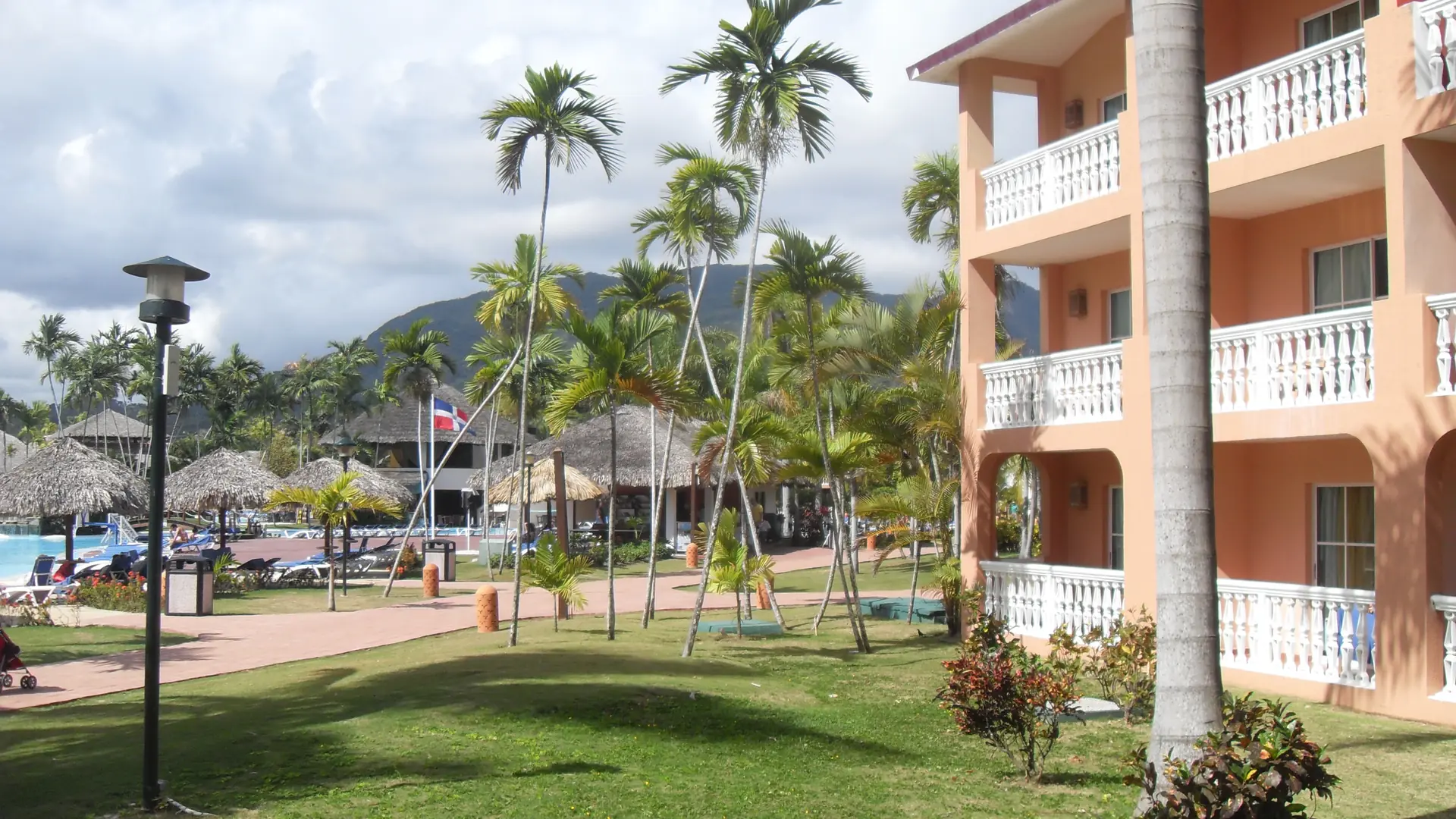 Sunny hotel gardens with palms and balconies on the Puerto Plata coast