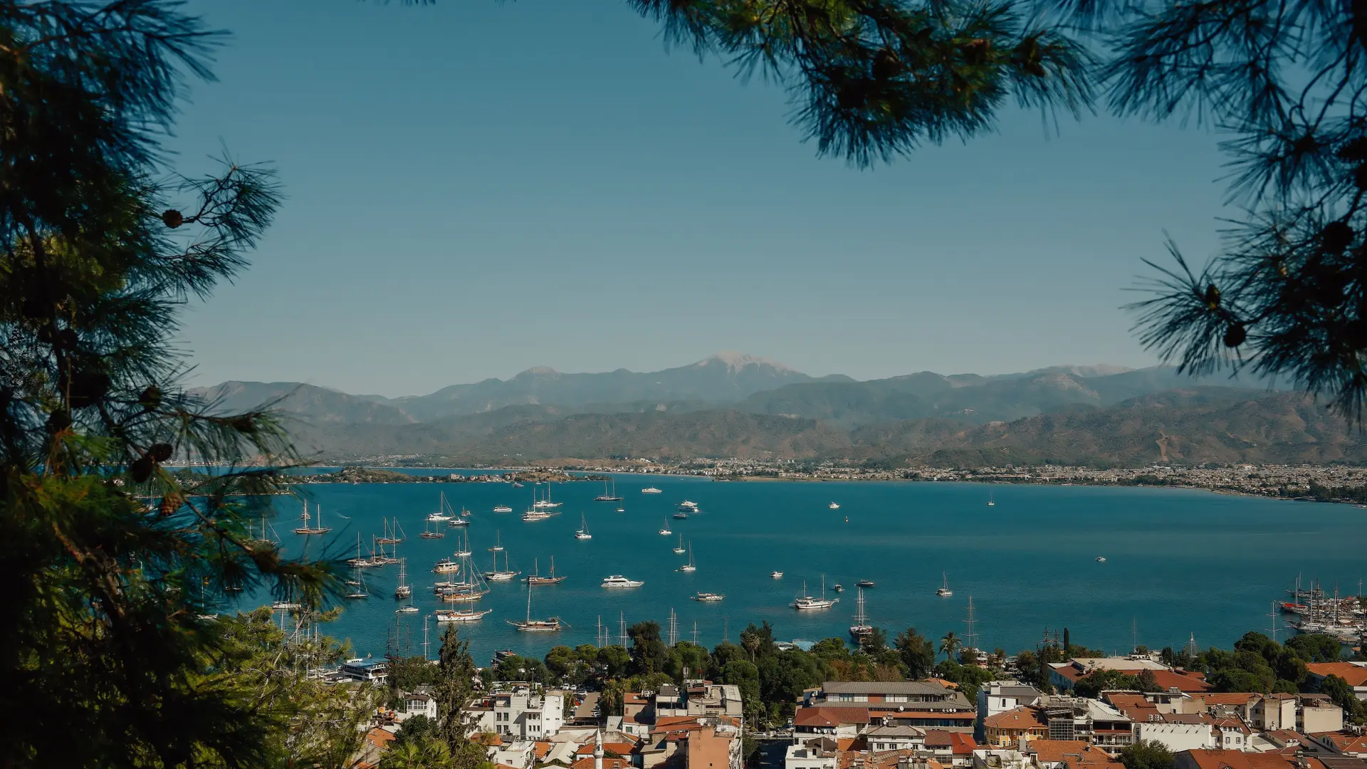 Sailboats on bright Fethiye Bay beneath green Lycian mountains