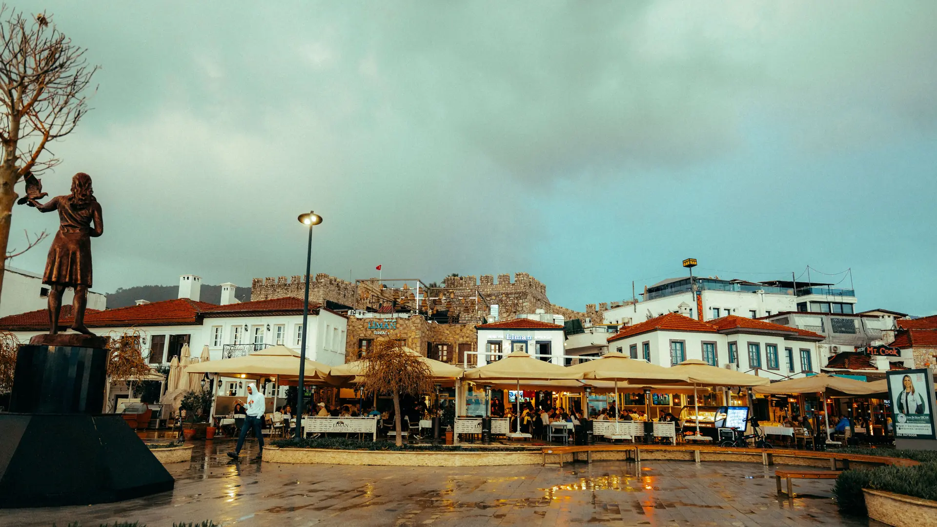 Marmaris old-town square with the castle quarter rising behind waterfront buildings