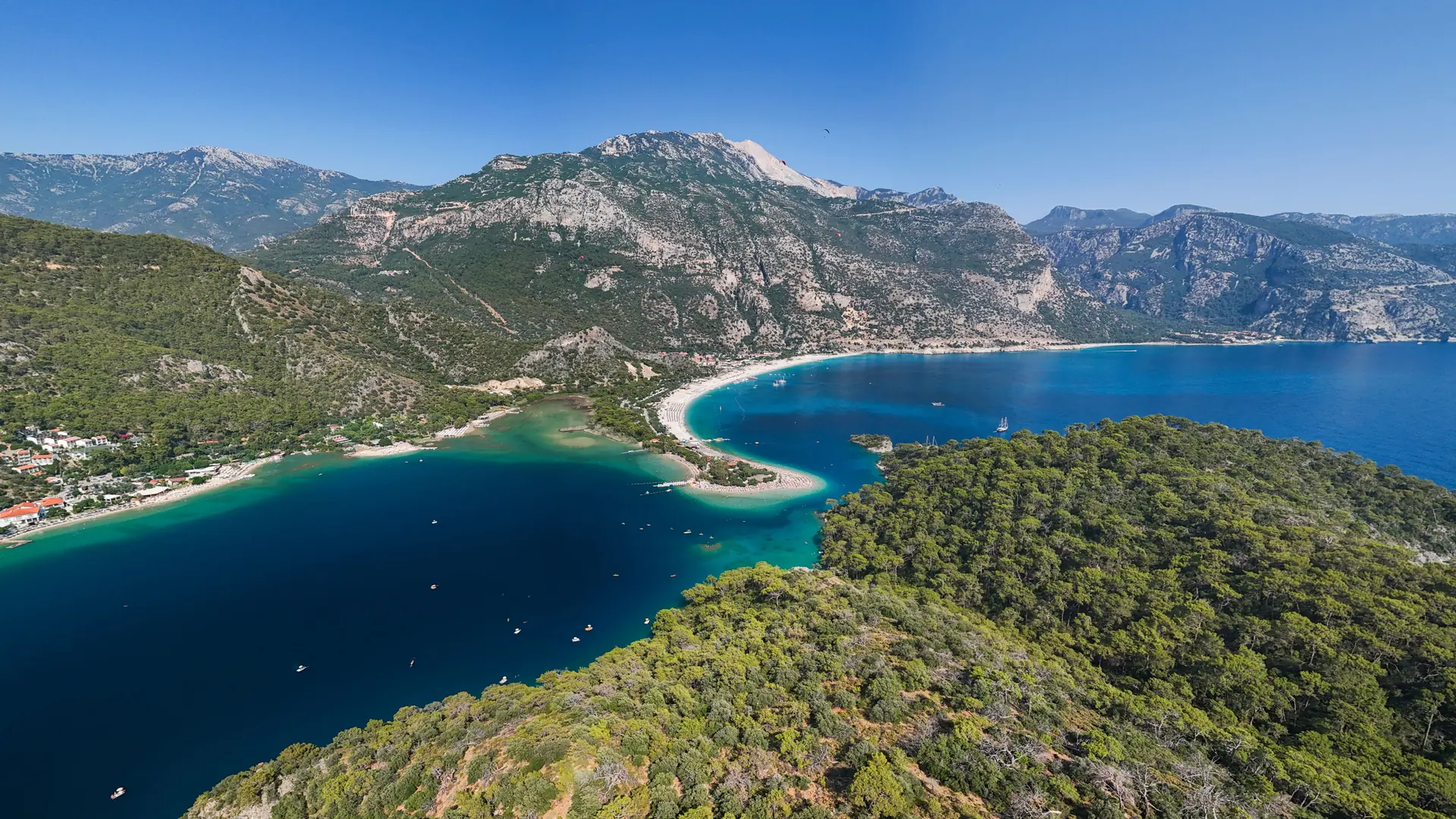 Turquoise Mediterranean bay and pine-covered Lycian coast in bright summer light