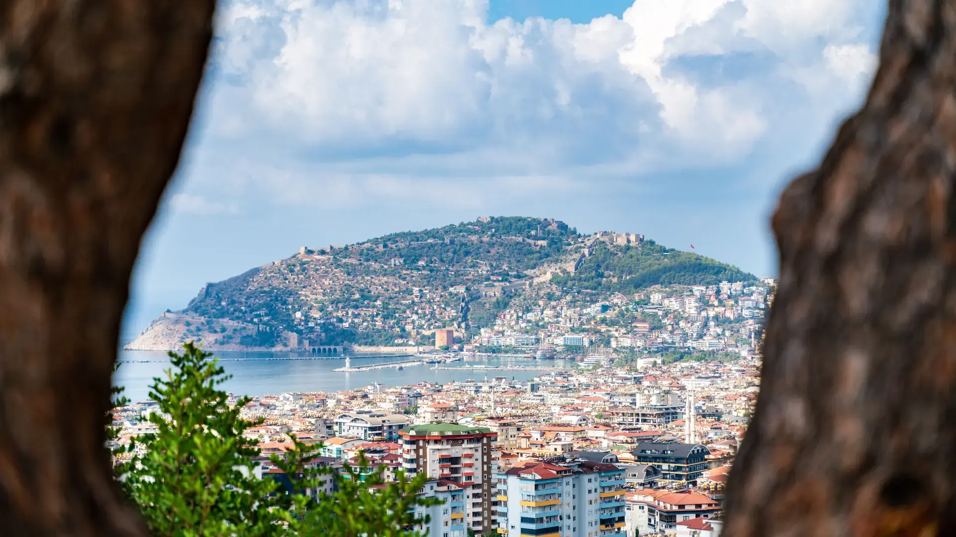 Alanya city and Mediterranean coastline seen from above beneath a clear summer sky
