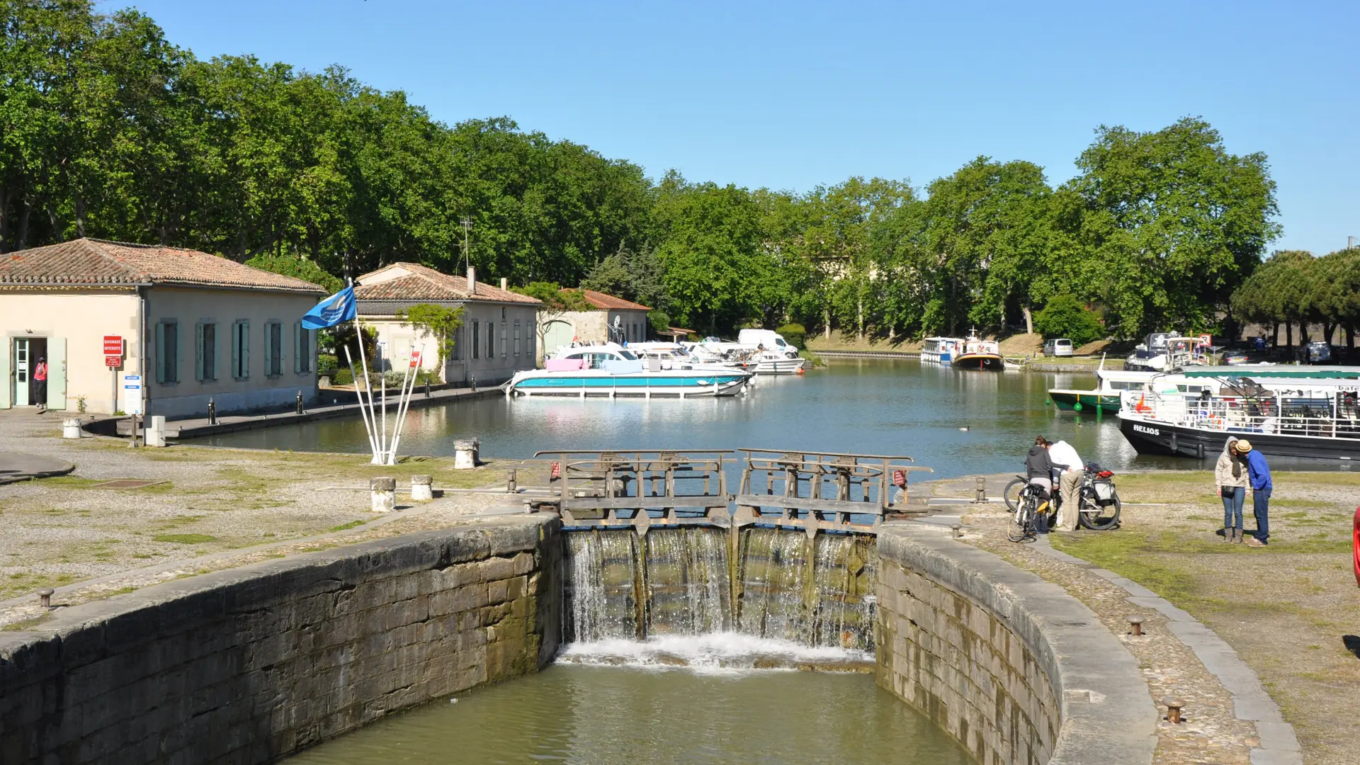 Boats in Carcassonne’s Canal du Midi port beyond the stone lock