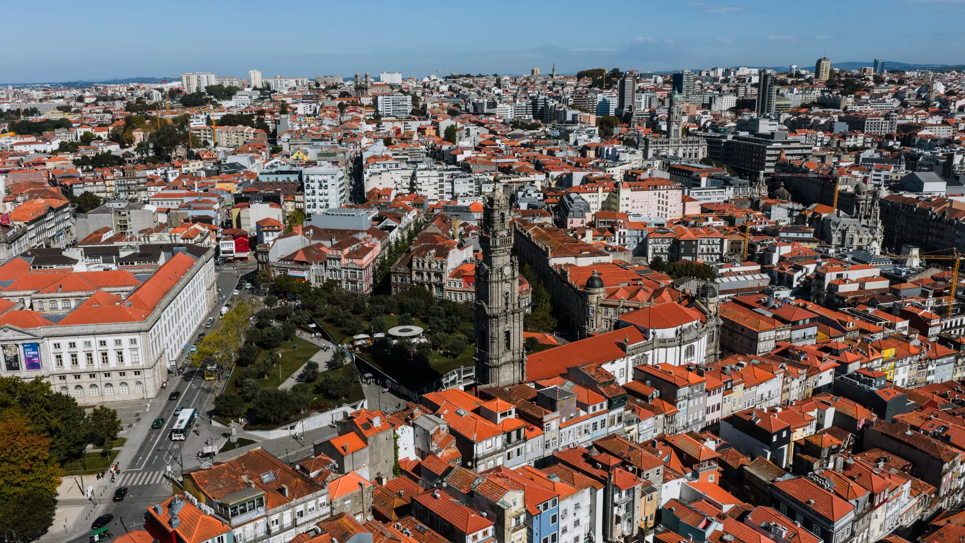 an aerial view of Porto's City Hall square and Clérigos Tower under a clear blue sky