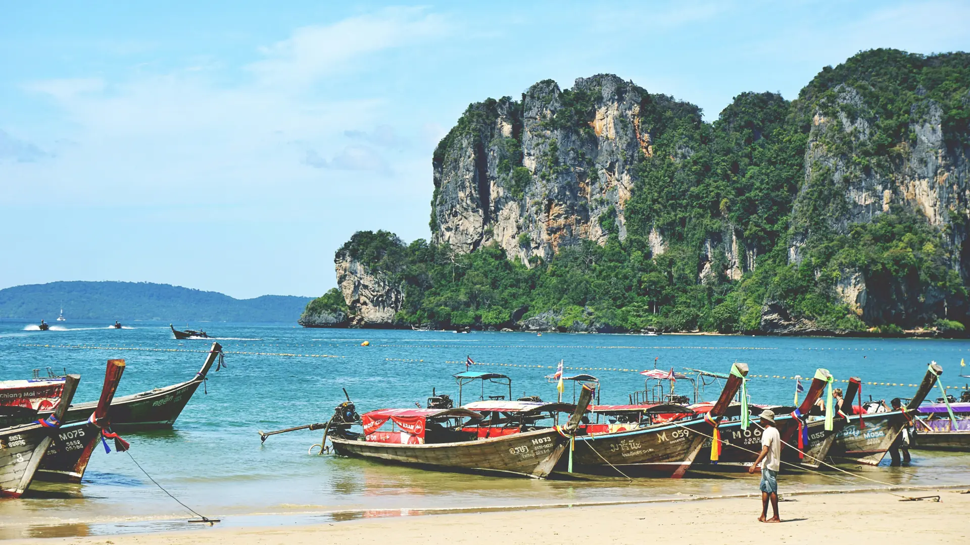Colourful long-tail boats lined up along Ao Nang Beach