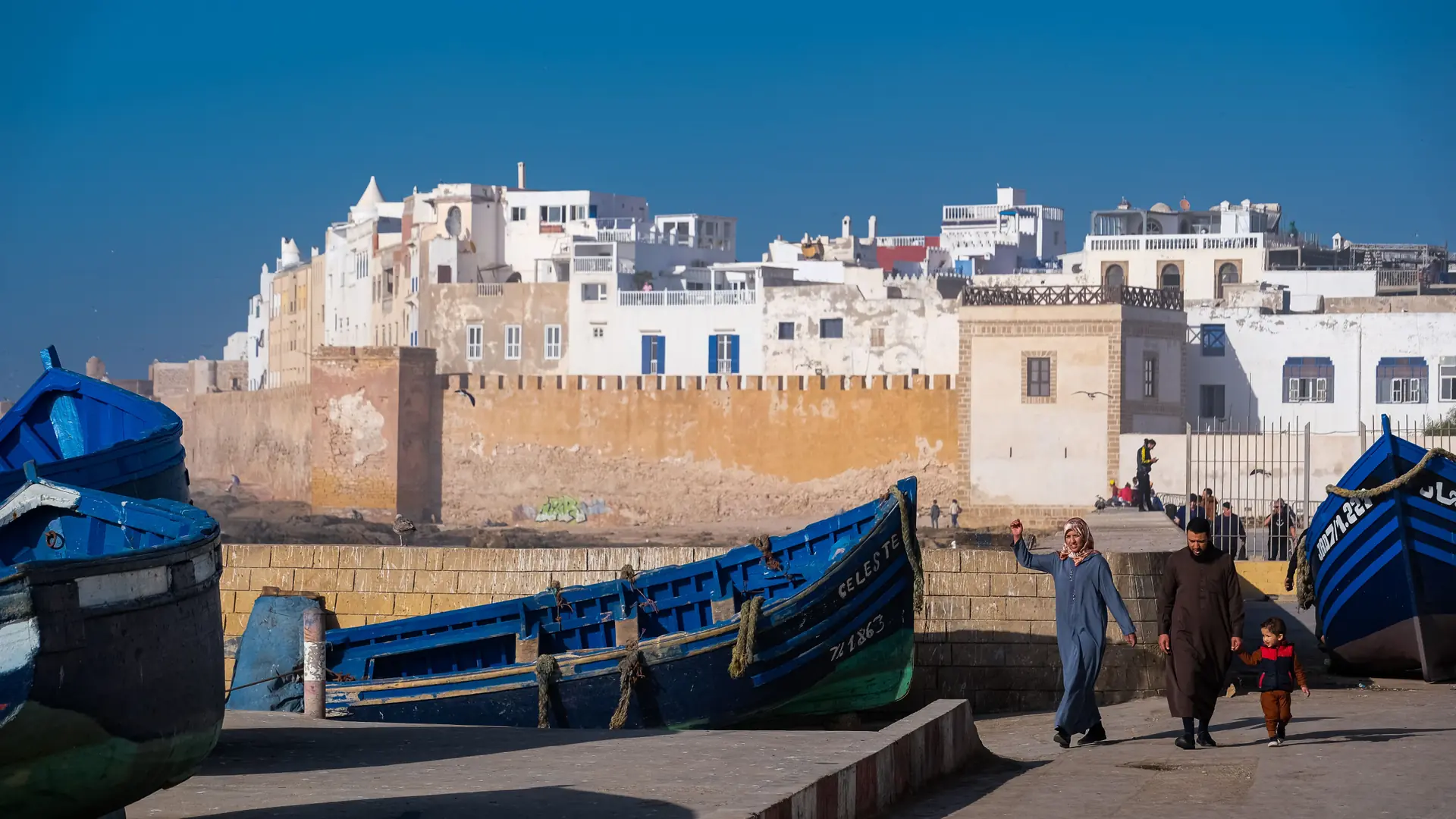 Fishing boats and stone ramparts on Essaouira’s sunny Atlantic waterfront