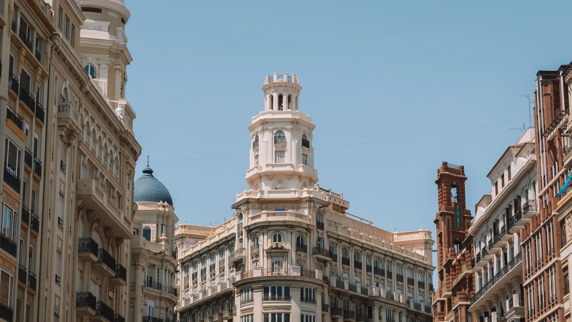 Sunlit Edificio Suay and neighbouring façades at Plaza del Ayuntamiento in Valencia