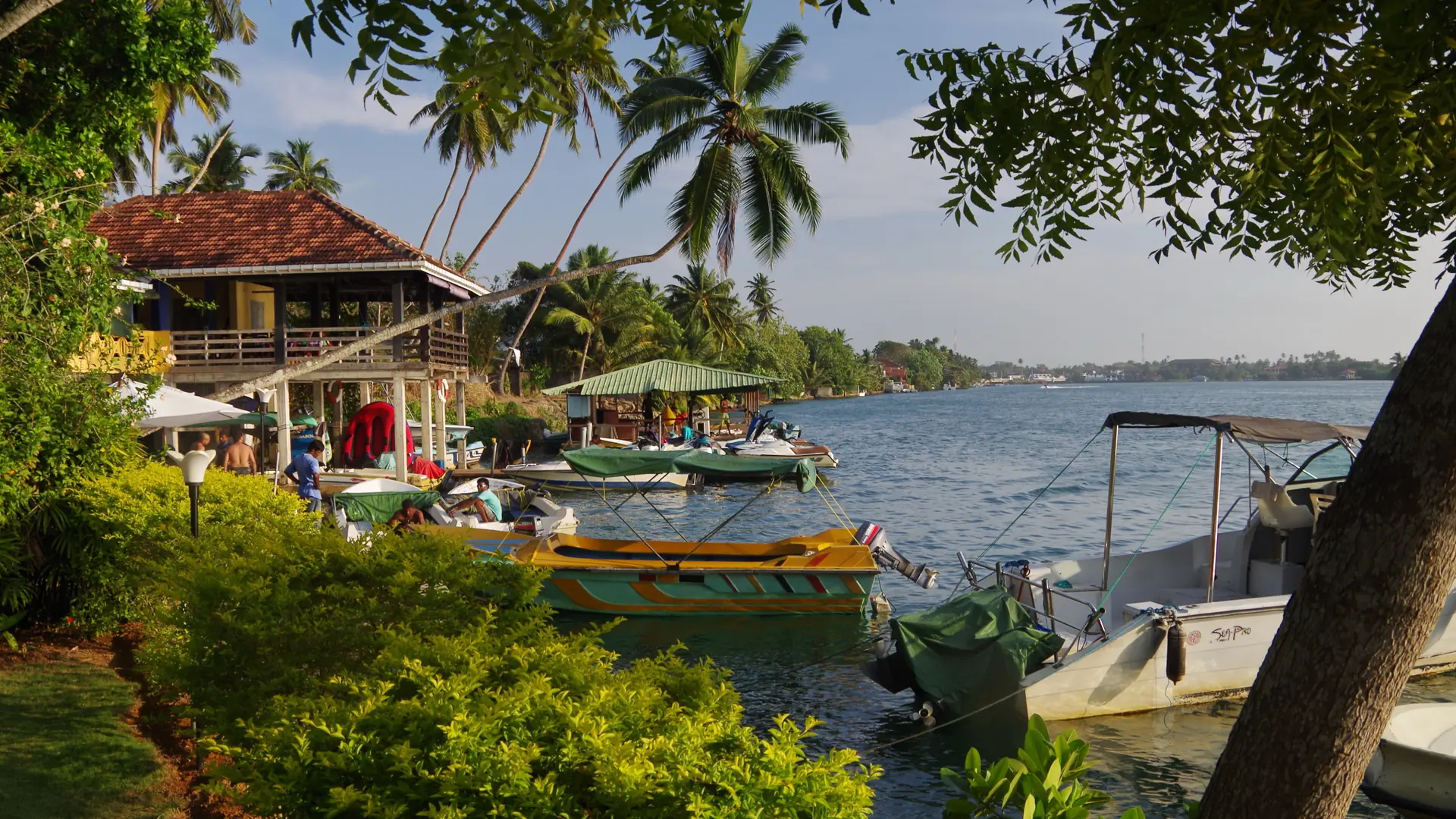 Small boats moored beside the Bentota River near Aluthgama