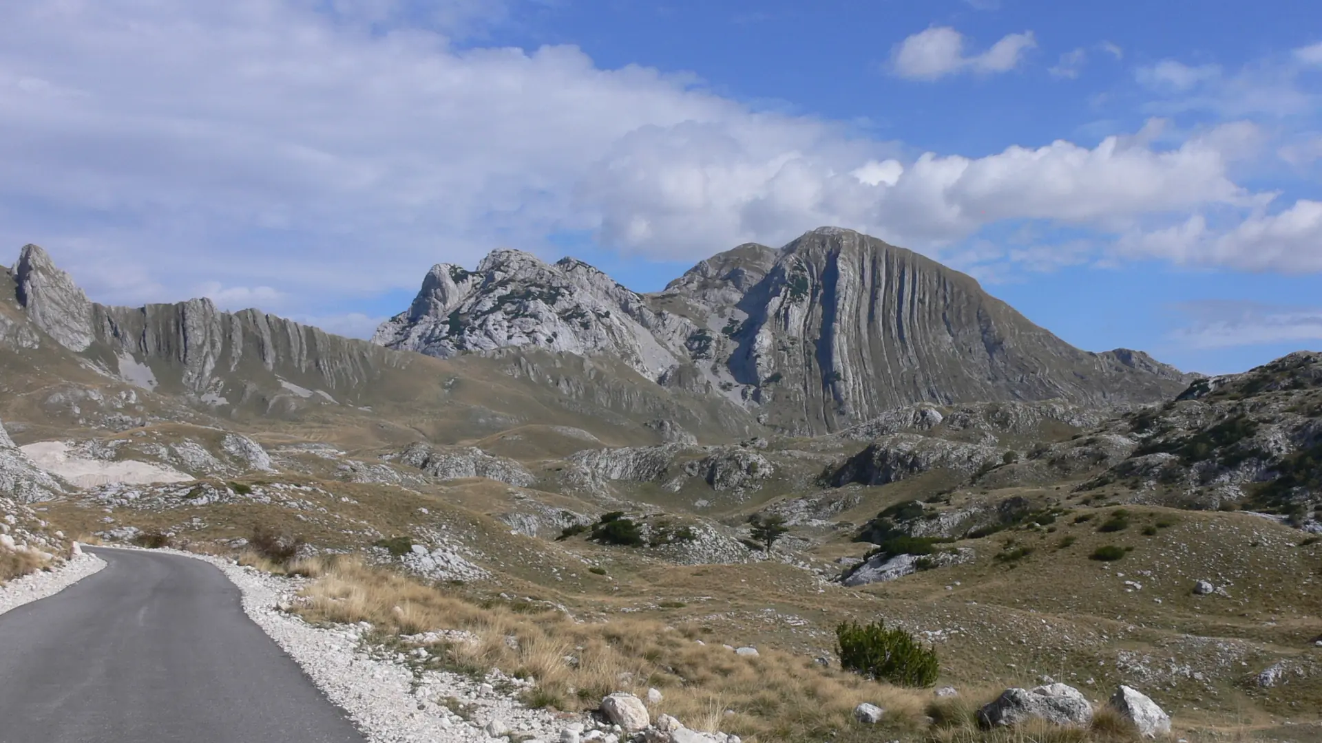 Sunny mountain road through Durmitor landscape