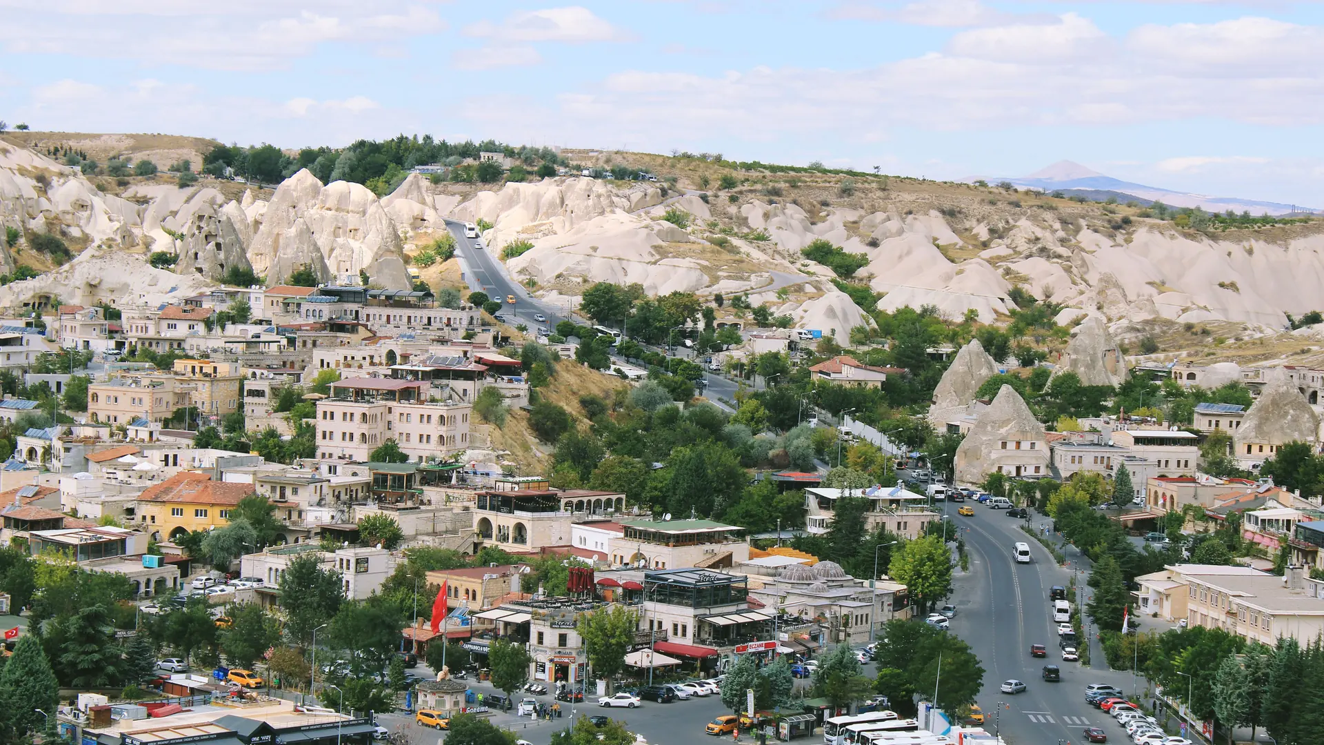 Sunlit Göreme town streets and pale fairy-chimney hills