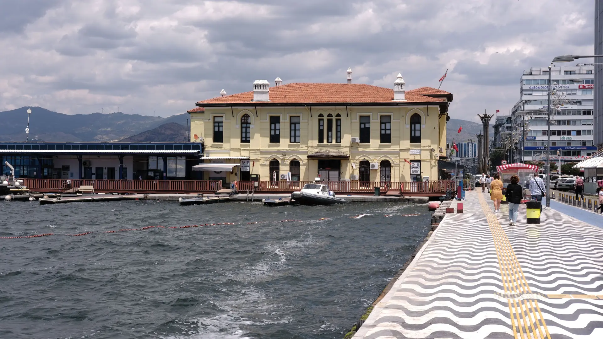 Historic waterfront building and busy promenade beside İzmir Bay