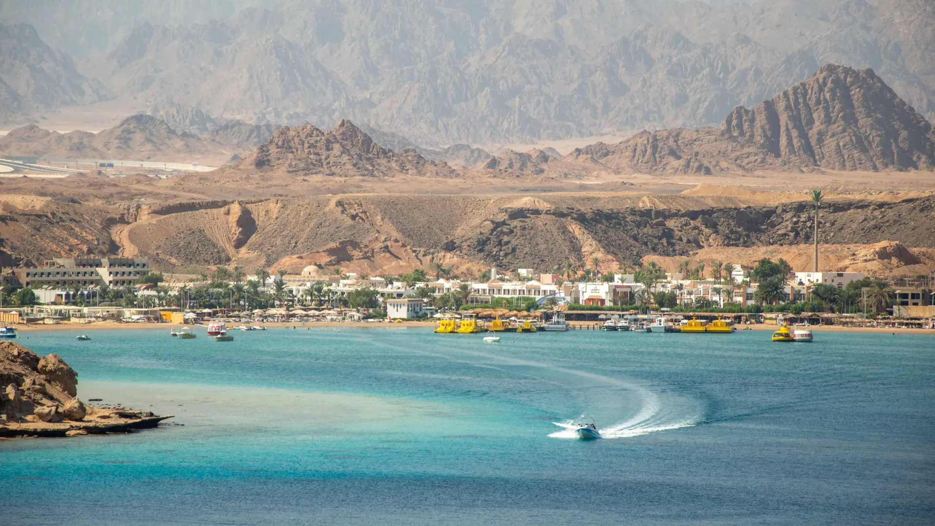 Sunlit turquoise bay and Sinai mountains on the Sharm El-Sheikh coast