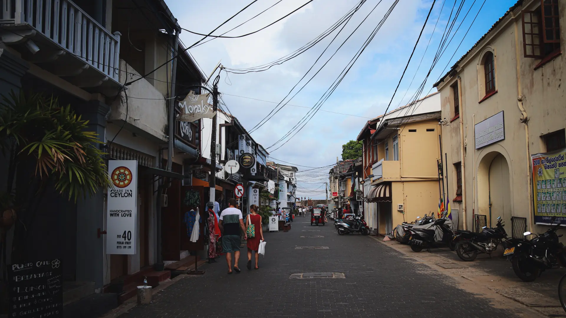 Sunny Galle Fort street with preserved historic facades and shaded verandahs