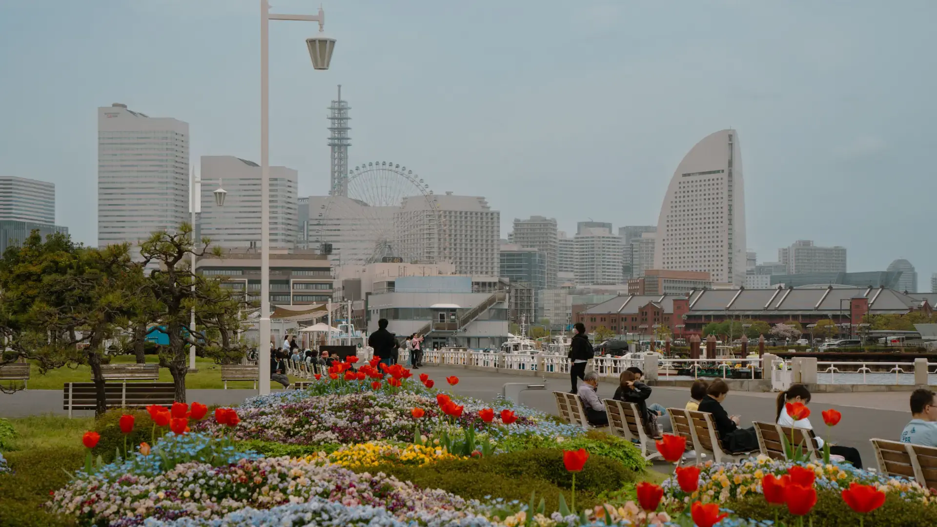 Yokohama's sunlit Minato Mirai skyline, Ferris wheel and blue harbour beneath a clear sky