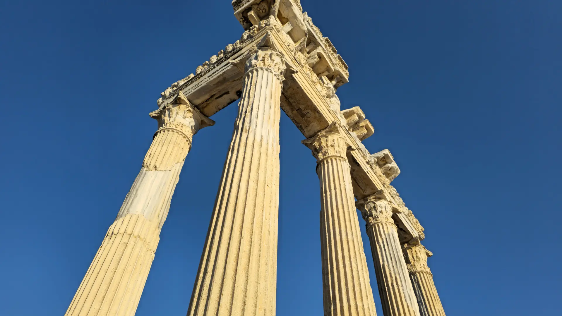 Ancient Side harbour and Temple of Apollo beside sparkling Mediterranean water