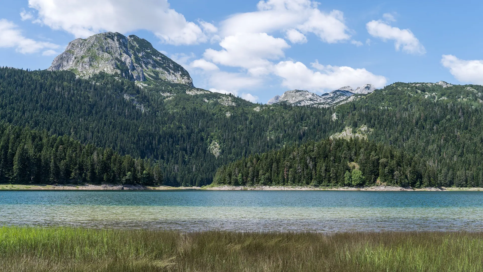 Black Lake and the rocky Durmitor ridge near Žabljak under clear daylight