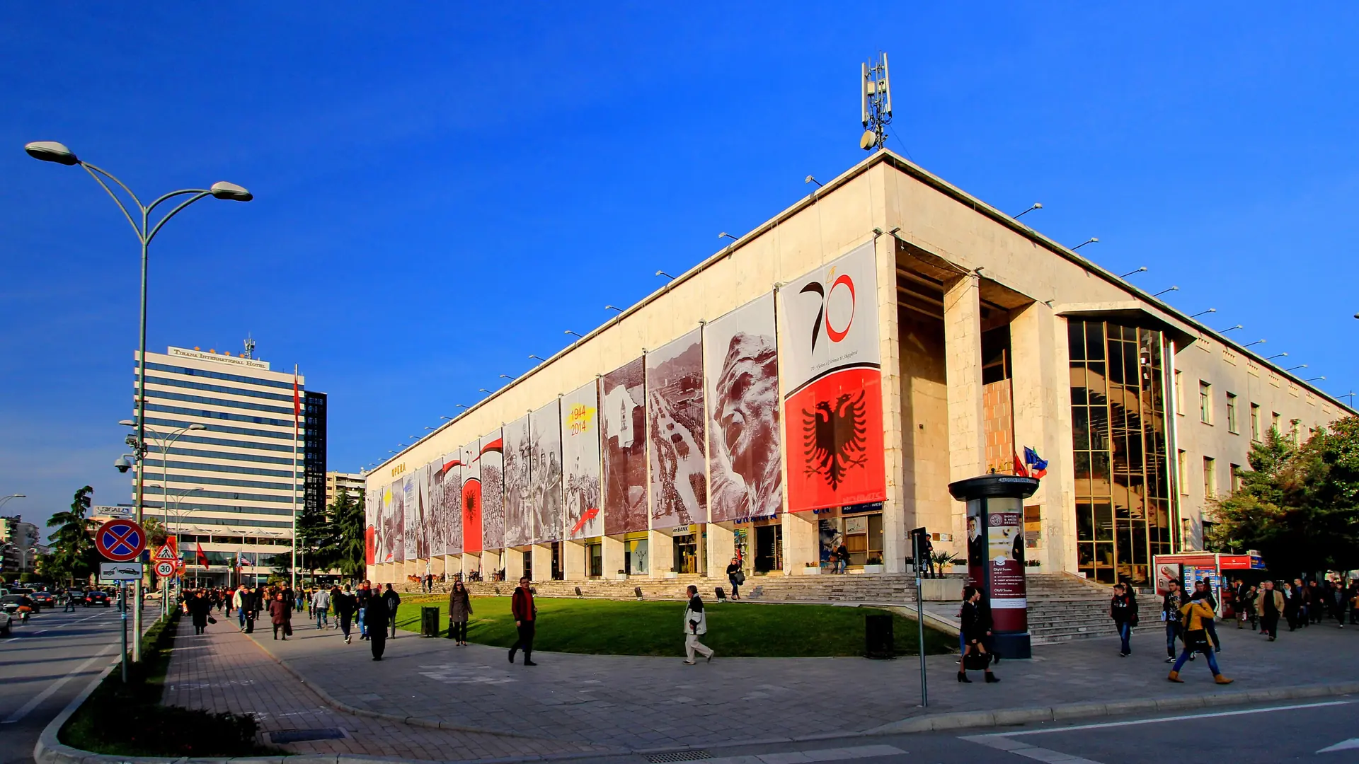The Palace of Culture on Skanderbeg Square in Tirana under a deep blue sky