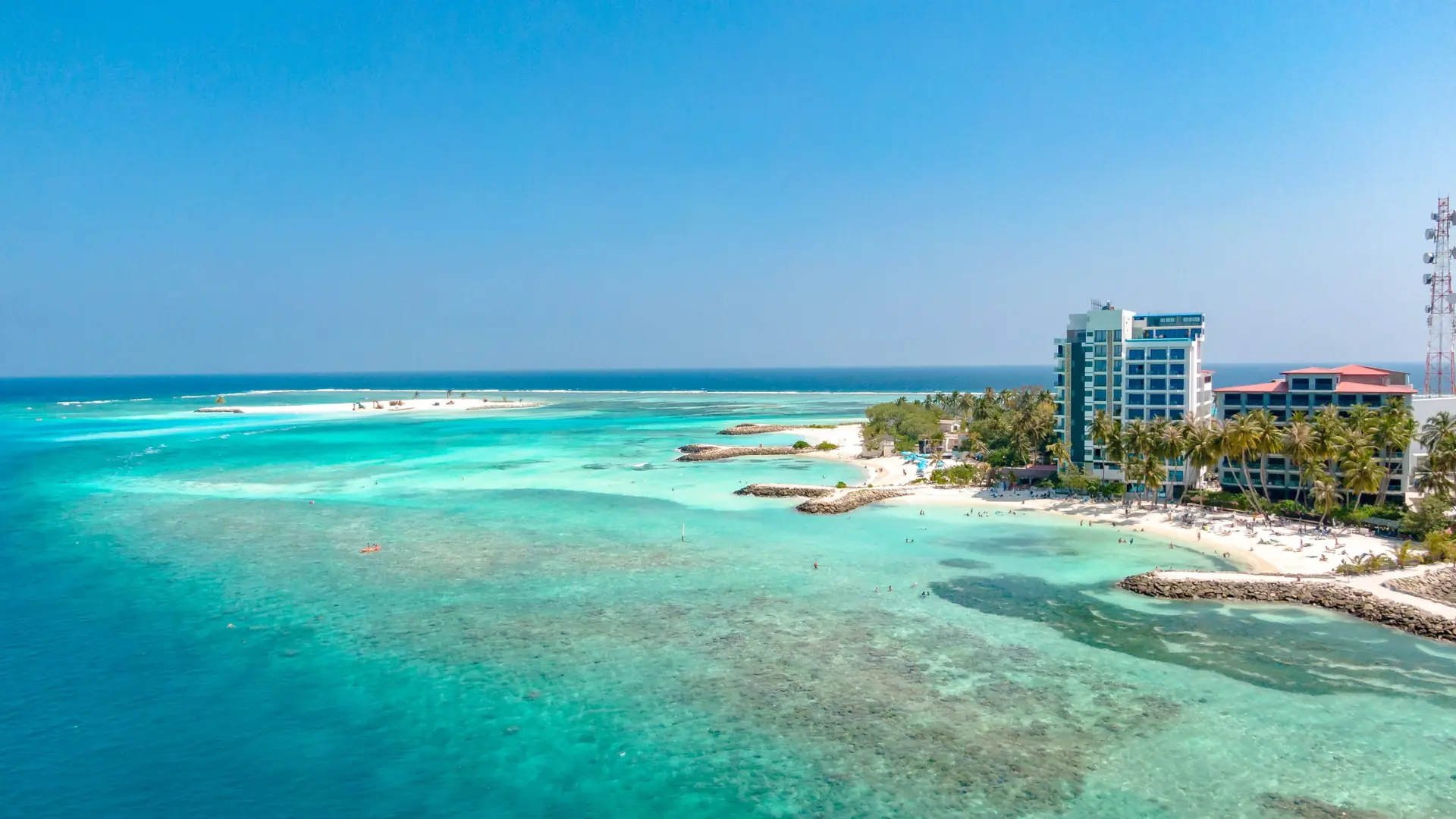 Sunny aerial view of Hulhumalé island, its beachfront and planned city blocks
