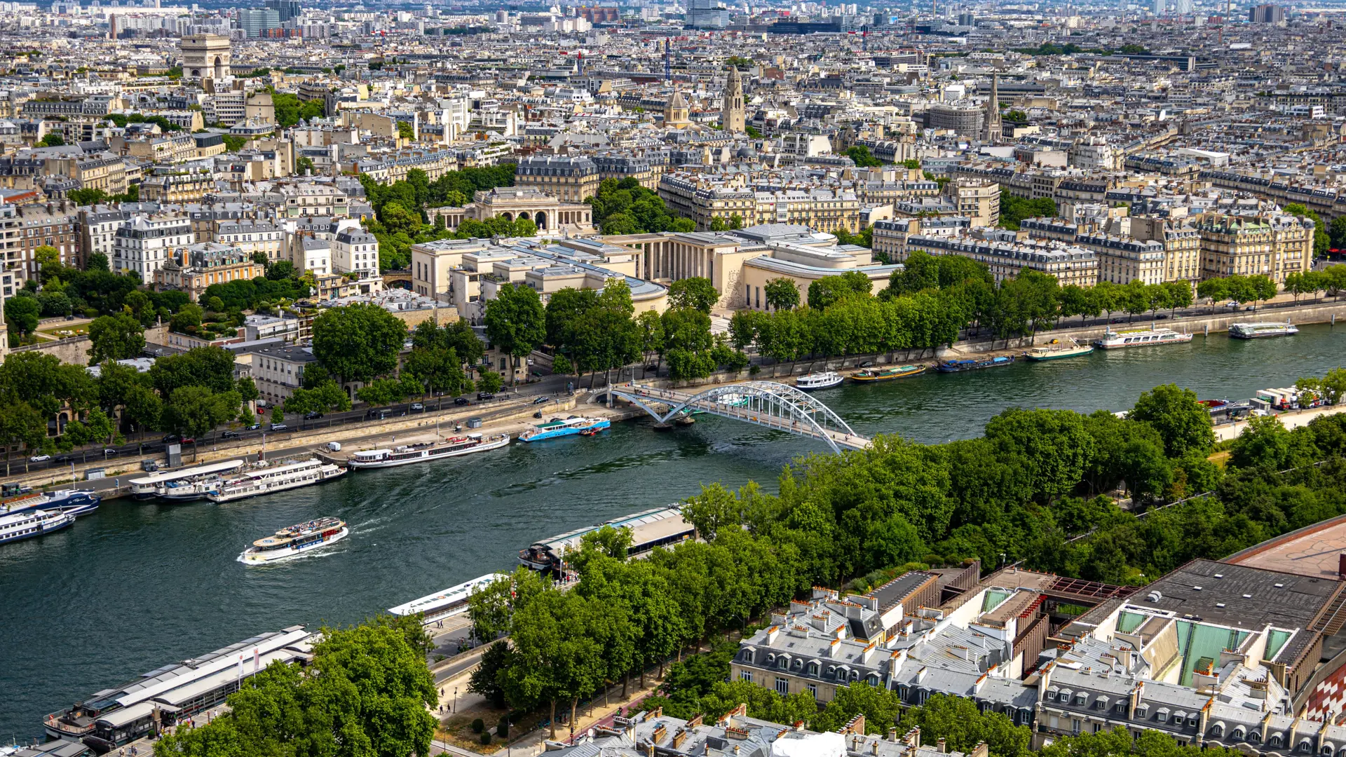 Paris rooftops and the Seine seen from above in bright daylight
