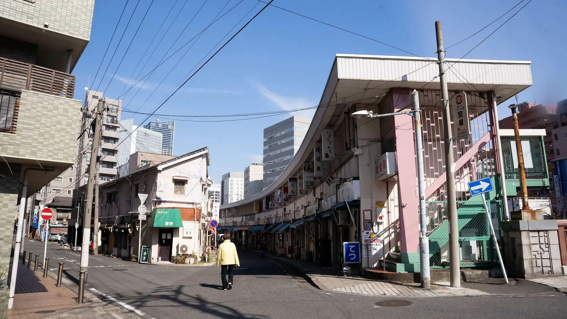 Miyakobashi's curved row of small Noge bars beside the canal in bright daylight