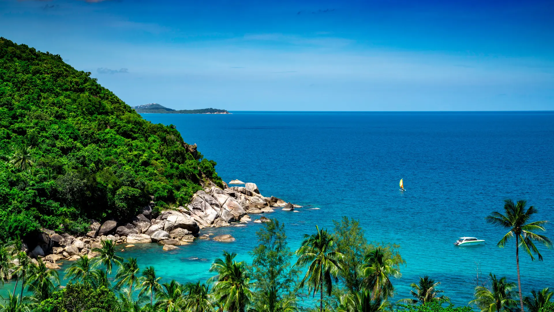 Azure Gulf water curving around Koh Samui's palm-covered coastline