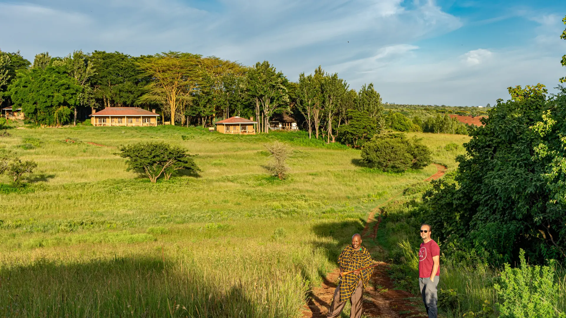 Green highland grounds and low buildings near Karatu, Tanzania