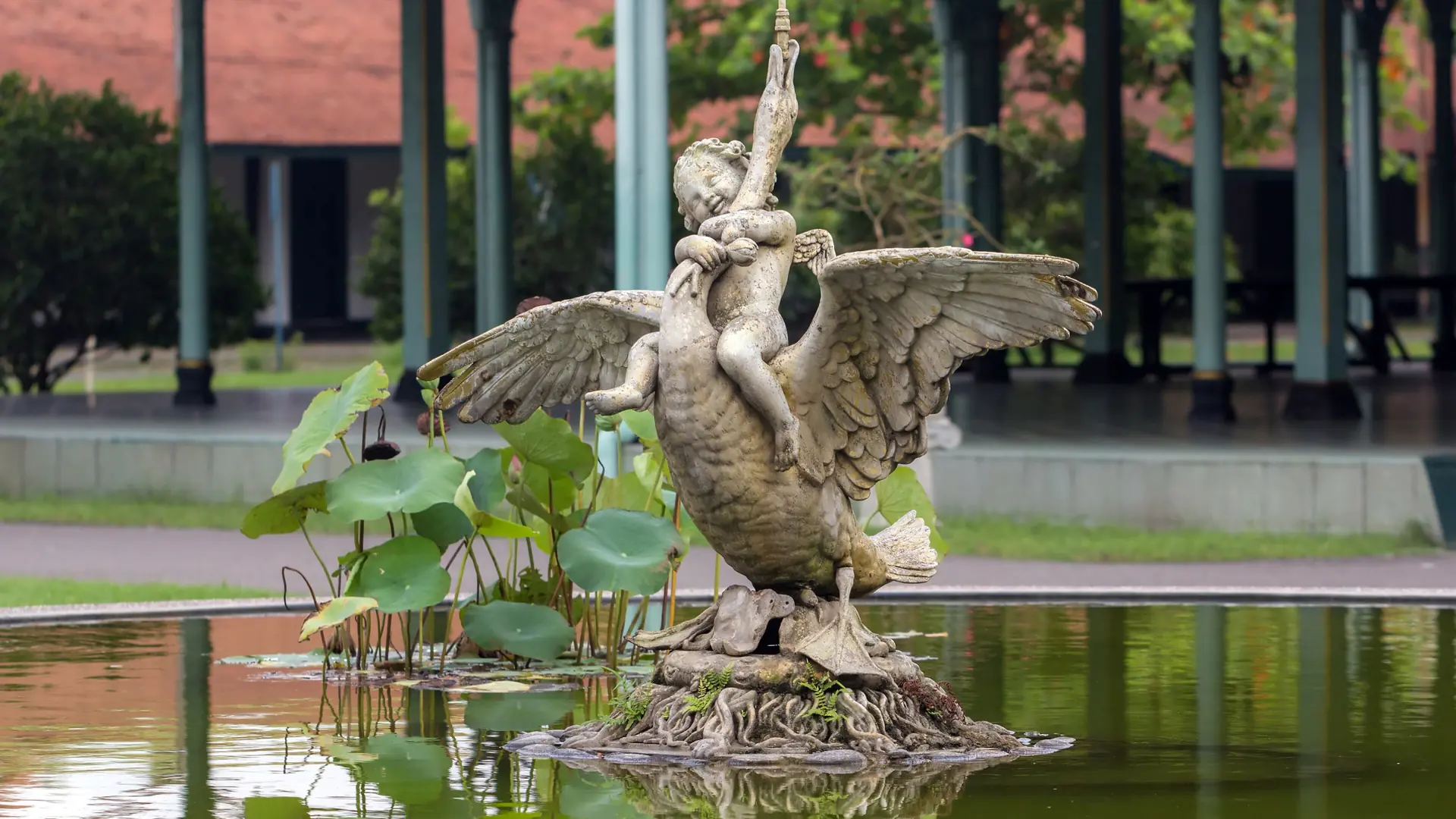 Winged fountain statue beside the courtyard pavilion at Mangkunegaran Palace in Surakarta