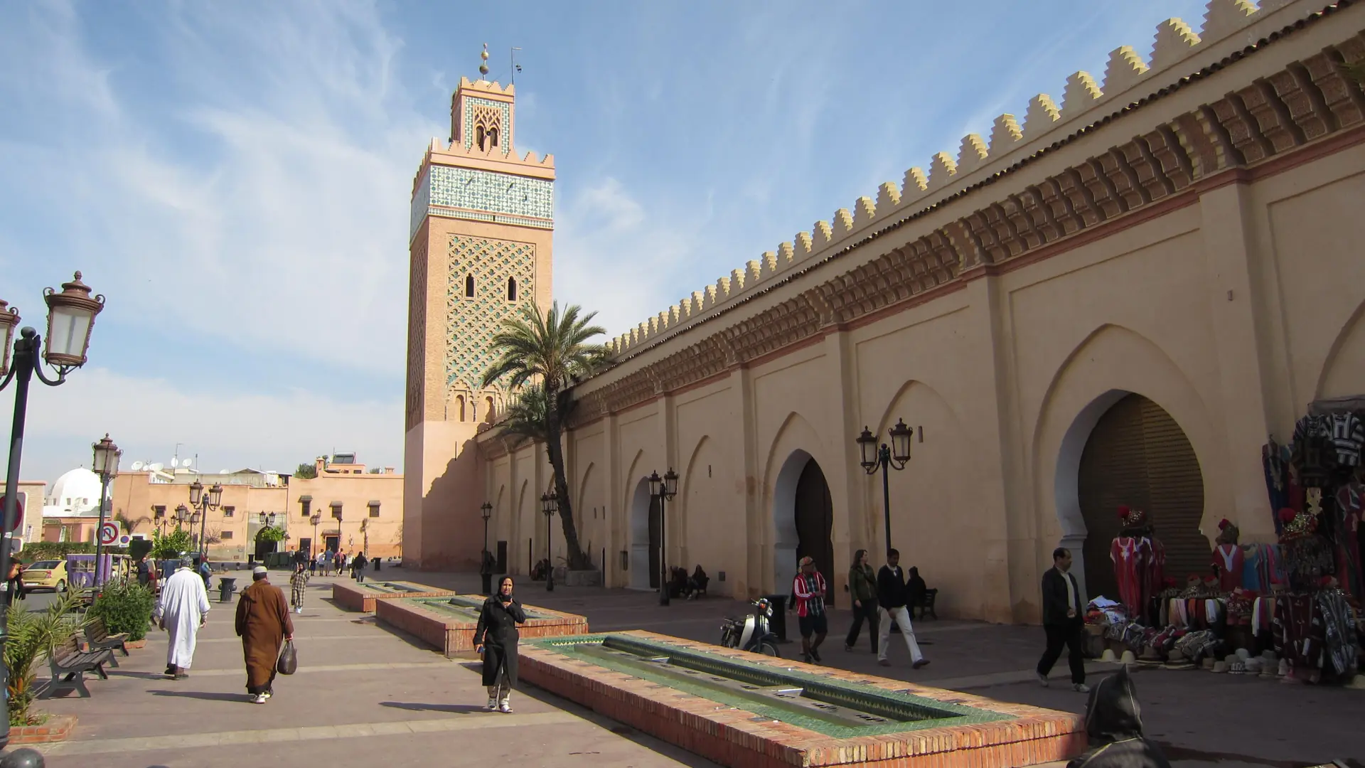 Kasbah Mosque minaret and arched street in Marrakech on a clear day