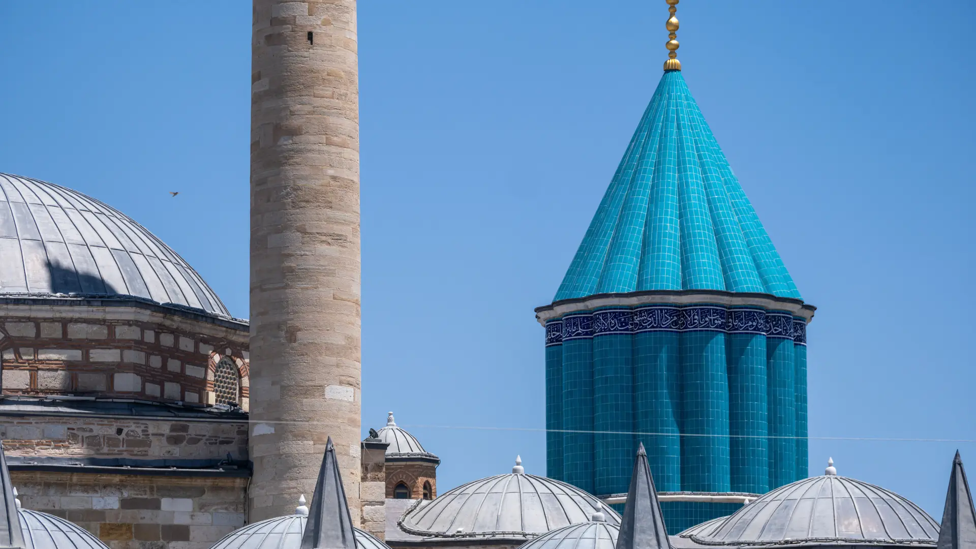 Turquoise dome and slender minaret of the Mevlana Museum in Konya